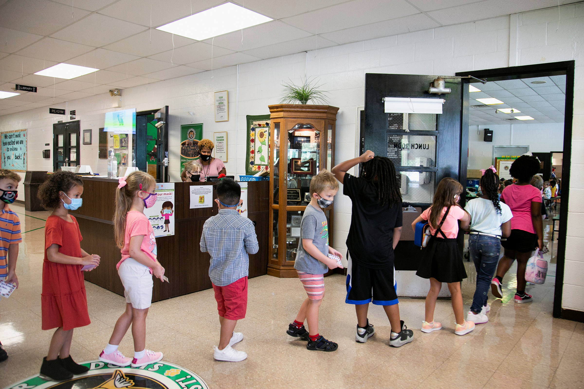 Students walk to the school cafeteria for lunch at Wilder Elementary School in Louisville, Ky. on Aug. 11.