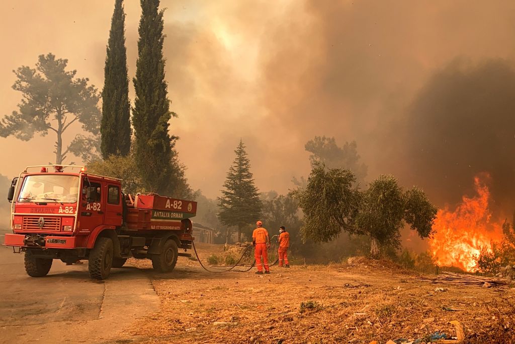 A firefighter battles with fire during a massive wildfire which engulfed a Mediterranean resort region on Turkey's southern coast near the town of Manavgat, on July 29, 2021.