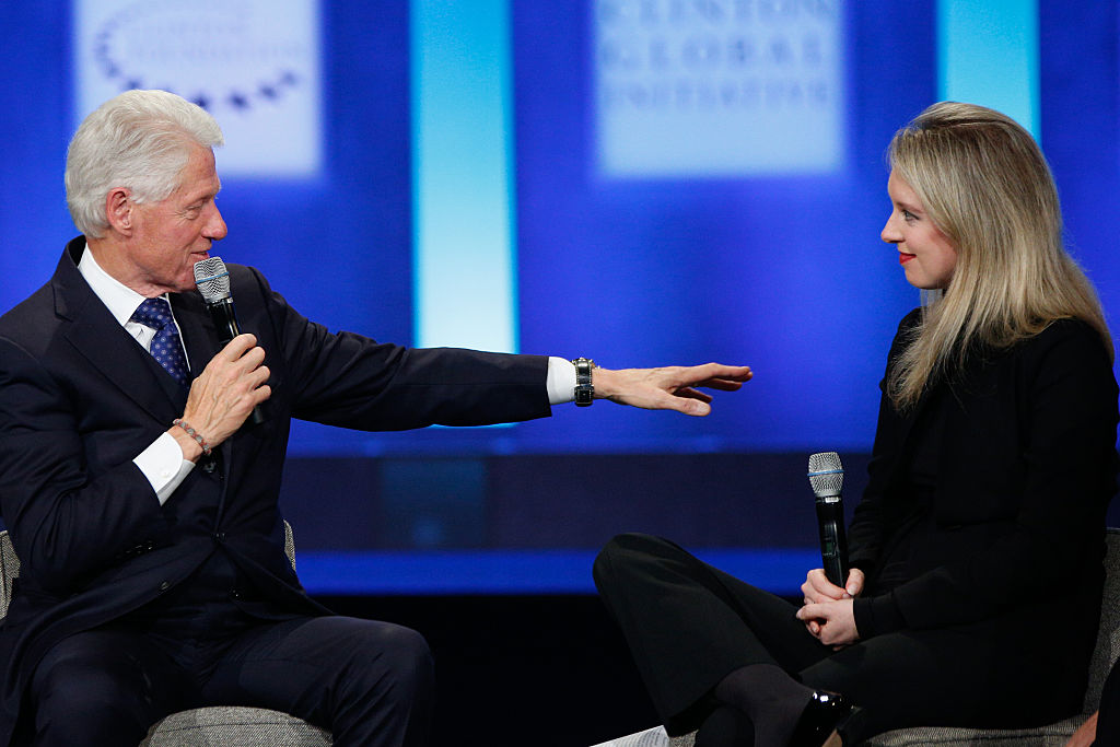 U.S. President Bill Clinton speaks as Elizabeth Holmes, founder and CEO of Theranos listens during the closing session of the Clinton Global Initiative 2015 on Sept. 29, 2015 in New York City. (JP Yim—Getty Images)