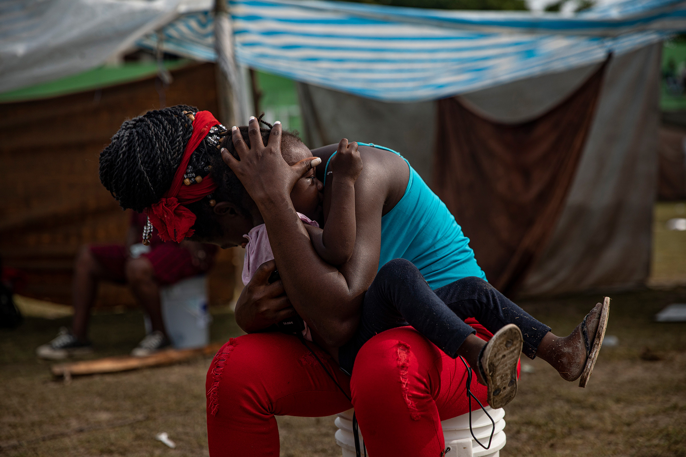 People displaced by the earthquake at a makeshift tent camp in Les Cayes on Aug. 19. (Adriana Zehbrauskas—The New York Times/Redux)