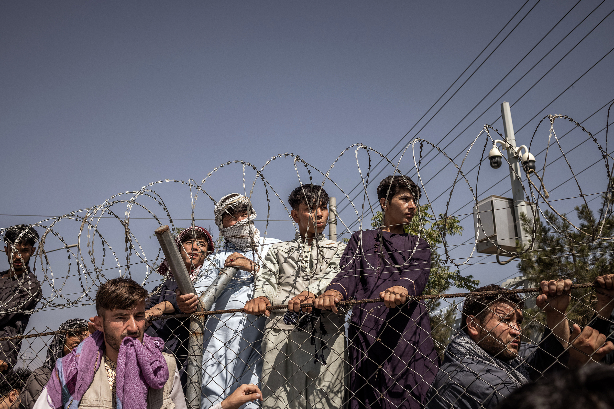 People seeking to leave Kabul gather at the international airport on Aug. 16, 2021.