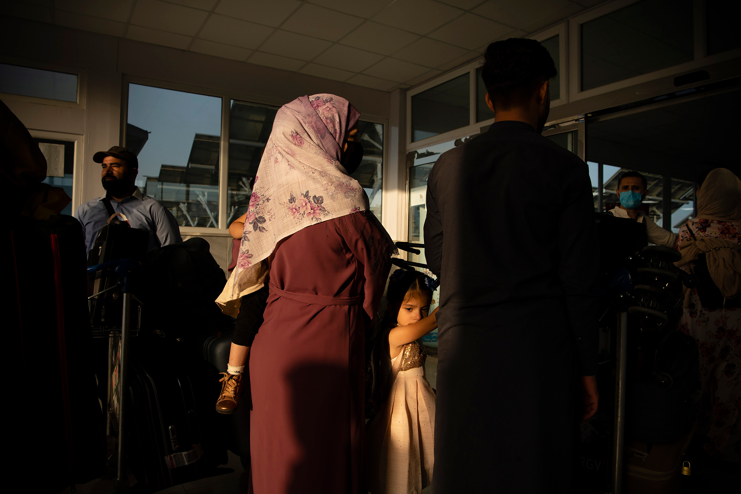 Ahead of the Taliban's arrival, Afghans and travelers pass through checkpoints at Hamid Karzai International Airport in Kabul on Aug. 15. (Kiana Hayeri—The New York Times/Redux)