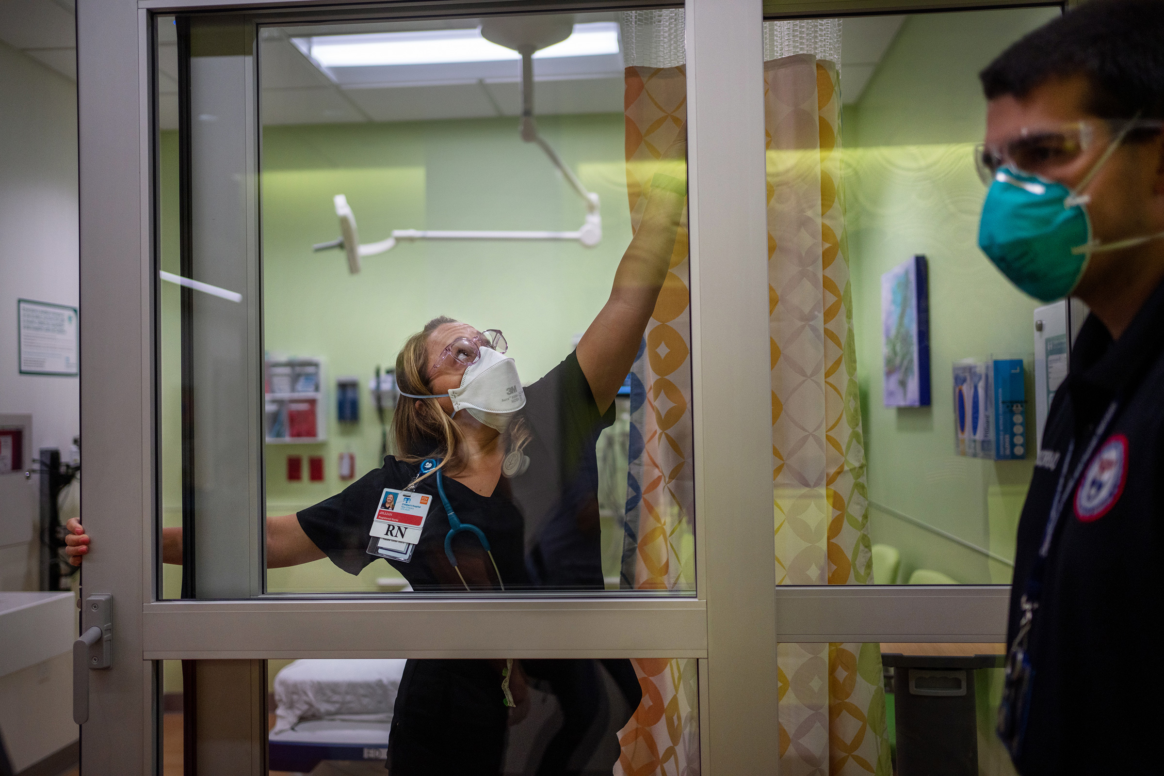 Jillian Nickerson tries to fix a stuck door in a newly opened room in the emergency department at Children’s Hospital New Orleans on Aug. 20, while Paul Decerbo from the Rhode Island-1 Disaster Medical Assistance Team looks on.