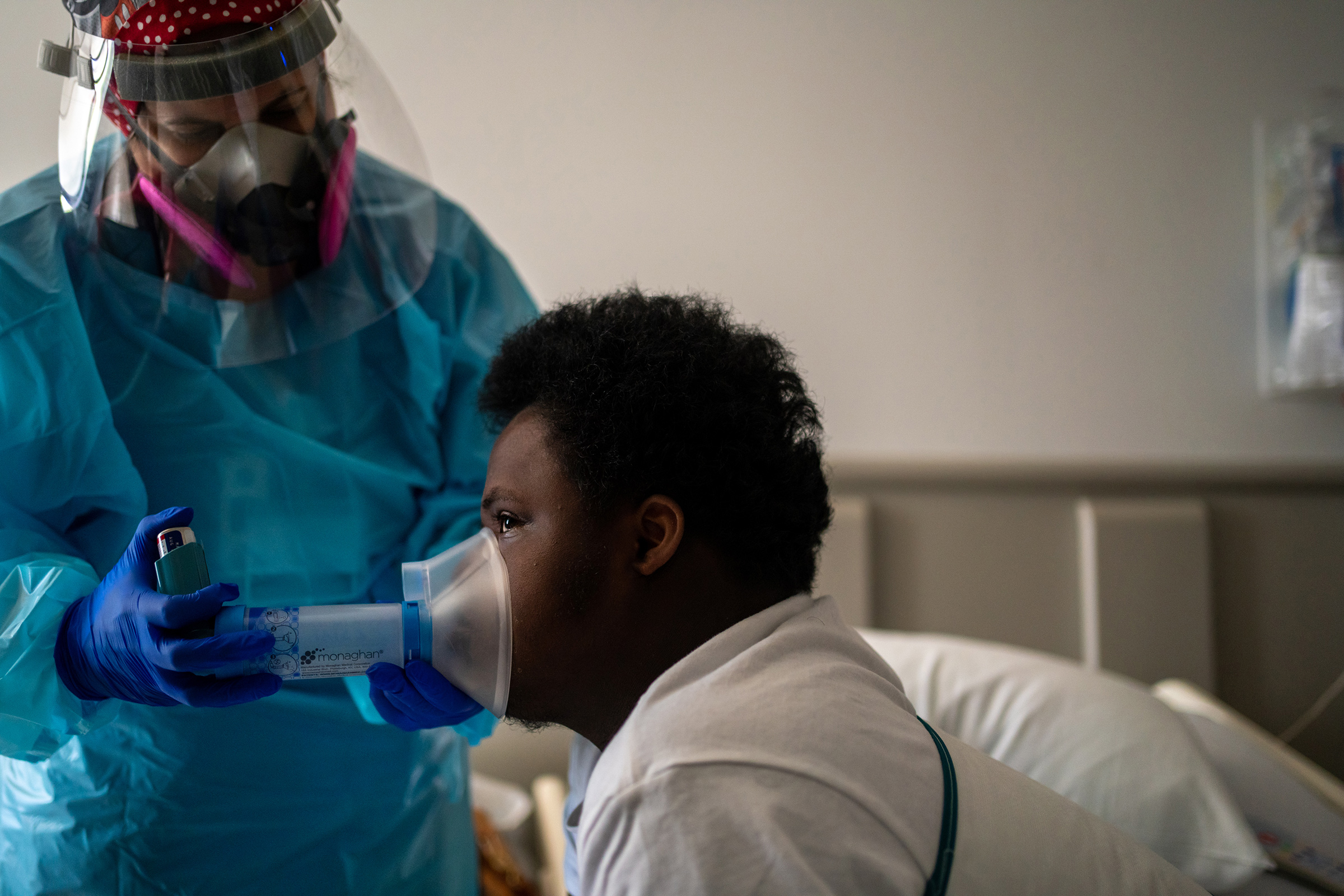 Courtney Willis provides respiration therapy to Nelson Alexis III, 17, in his room at Children’s Hospital New Orleans. Nelson, who has Down syndrome, was diagnosed with the virus in late July.