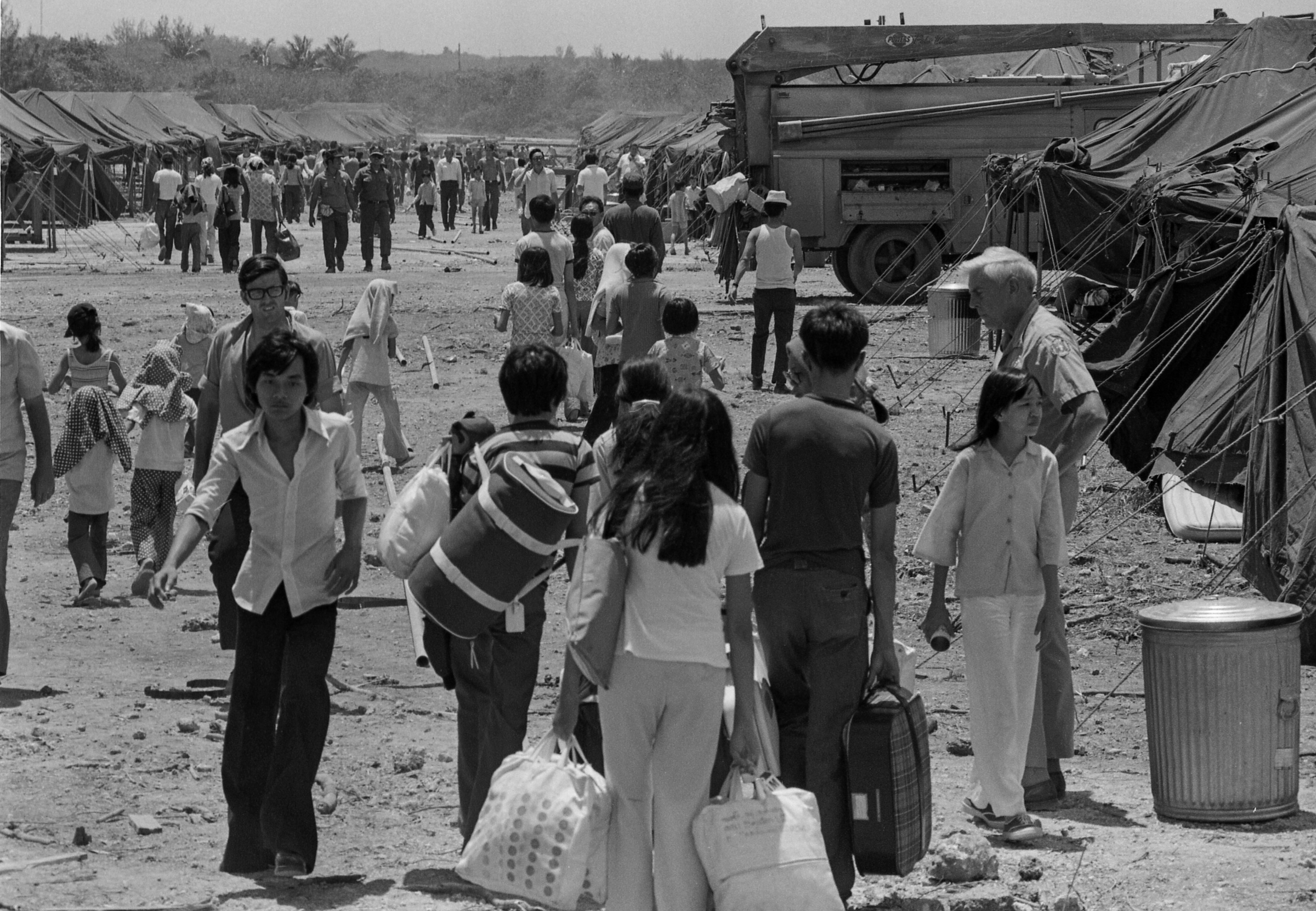 More than 3,000 refugees from South Vietnam enter the camp at Crote Point in Guam Naval Base after they were shifted from Clark Air Base in the Philippines, April 26, 1975. (Bettmann Archive/Getty Images)