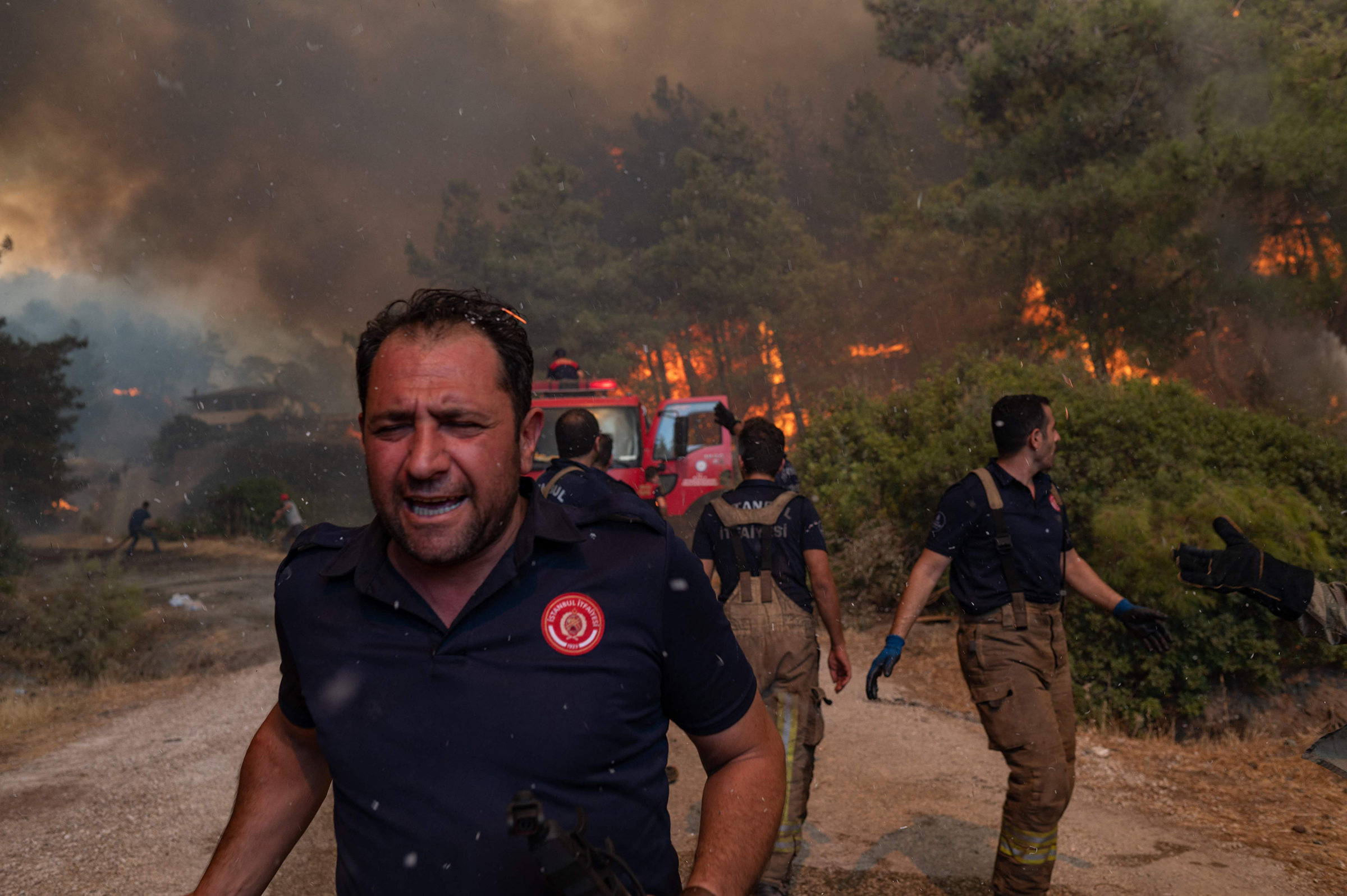 Firefighters battle a wildfire in Mugla, Marmaris district, Turkey, on Aug. 2. Turkey's struggles against its deadliest wildfires in decades come as a blistering heatwave grips southeastern Europe. (Yasin Akgul—AFP/Getty Images)