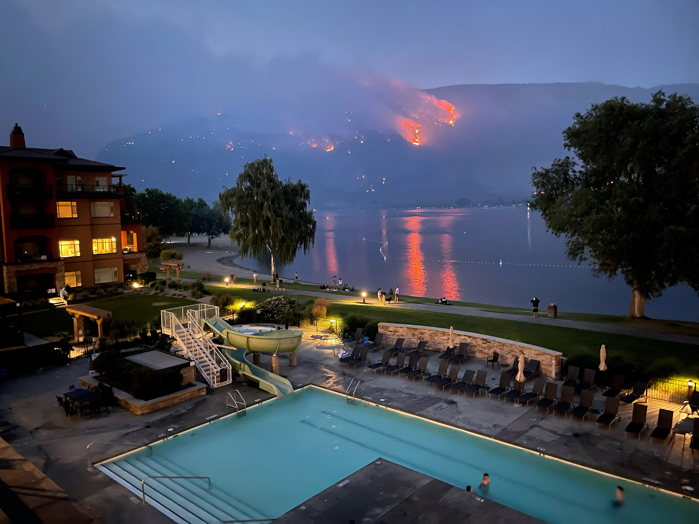 View of a beach resort as a wildfire burns on a hillside in Osoyoos, British Columbia, Canada, on July 20.