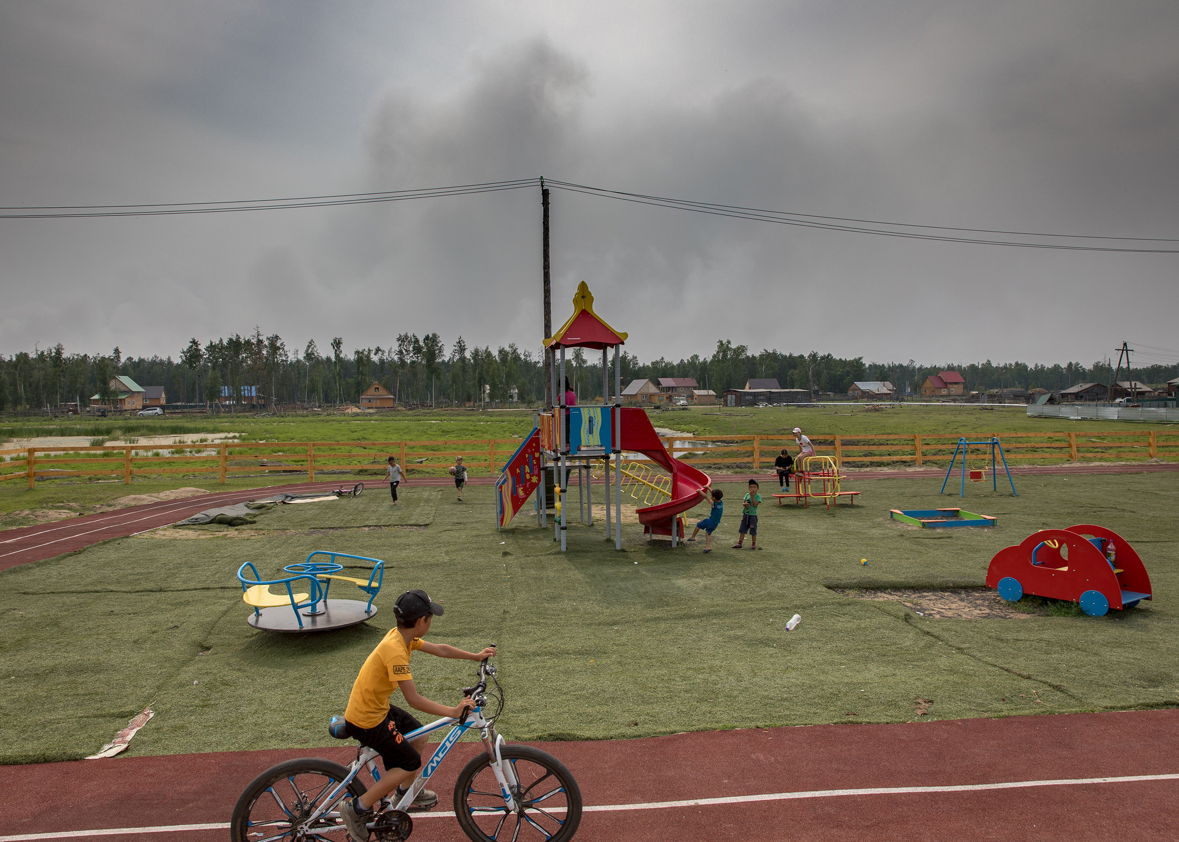 Smoke from a forest fire 3 kilometers away, seen from a playground in the village of Dikimdya.