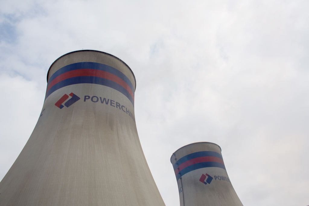 The logo of Power Construction Corp. of China (PowerChina) is displayed on cooling towers at the Chinese-built Port Qasim coal power plant in Sindh Province, Pakistan, on Wednesday, Sept. 19, 2018. (Asim Hafeez–Bloomberg/Getty Images)