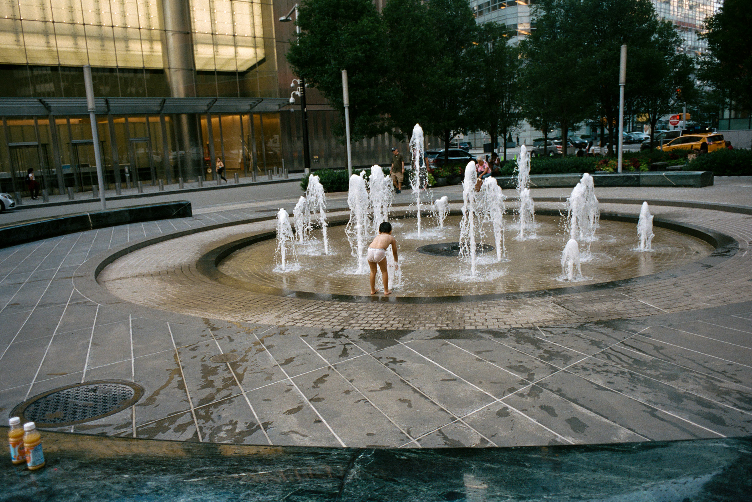 A child cools off in a fountain just north of the World Trade Center, Sept. 1, 2021.