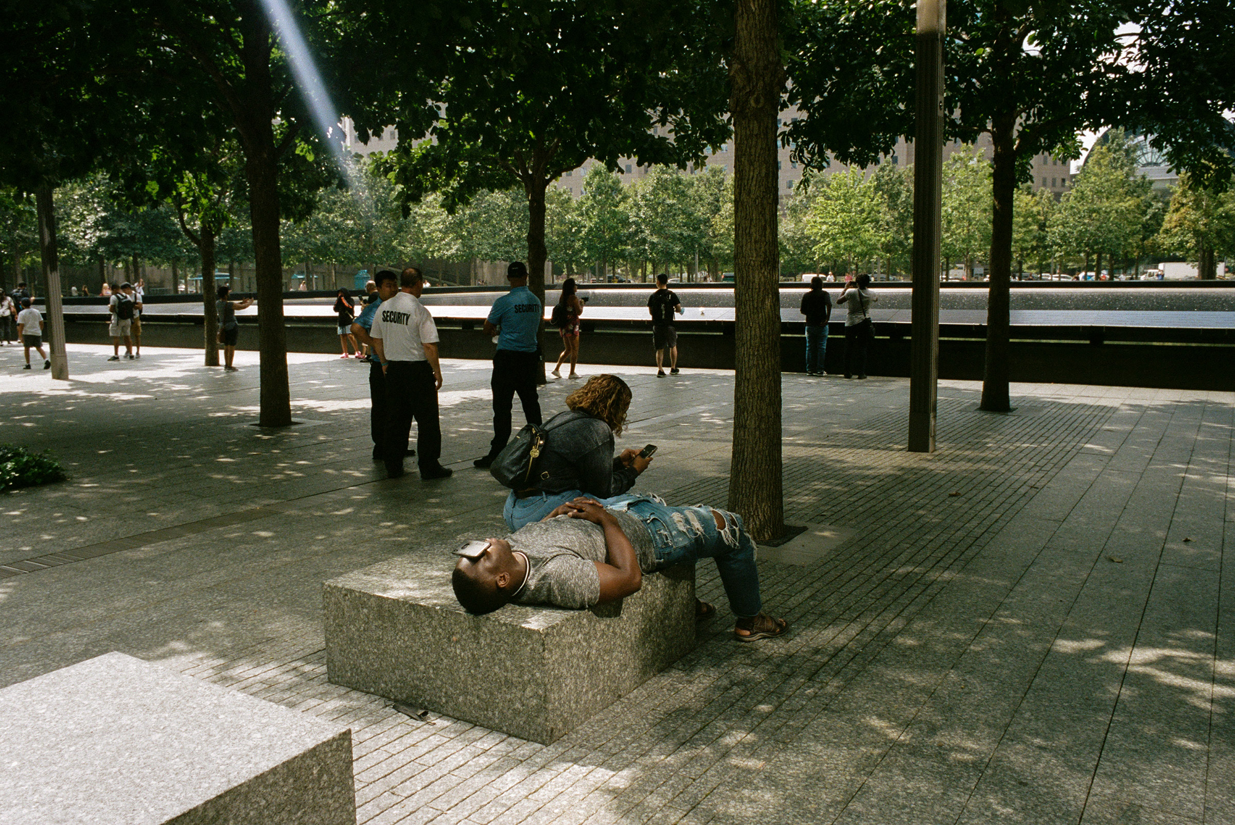 A man rests at the 9/11 memorial, Aug. 31, 2021. (Daniel Arnold for TIME)