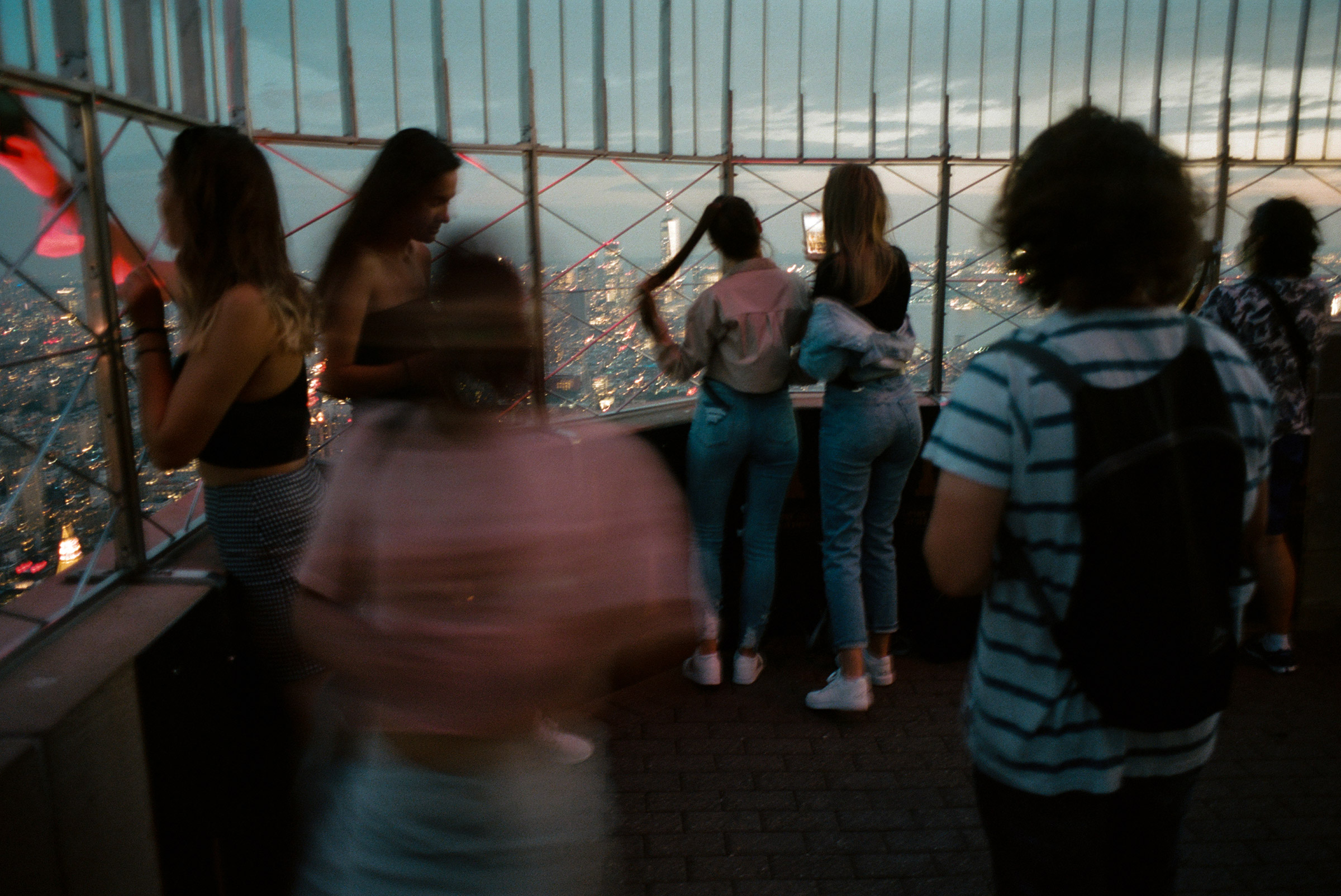 A group of young tourists at the Empire State Building observation deck gasp at the sight of the city from above, Sept. 1, 2021. (Daniel Arnold for TIME)