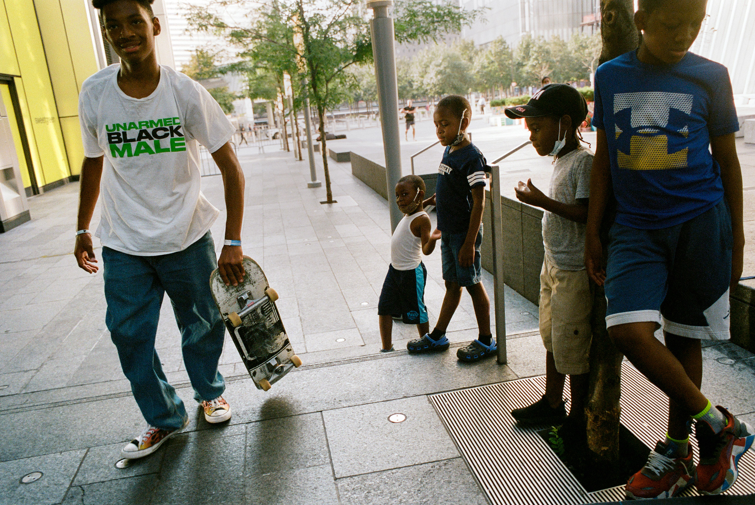 A group of kids admire a young skateboarder near One World Trade, Aug. 26, 2021. (Daniel Arnold for TIME)
