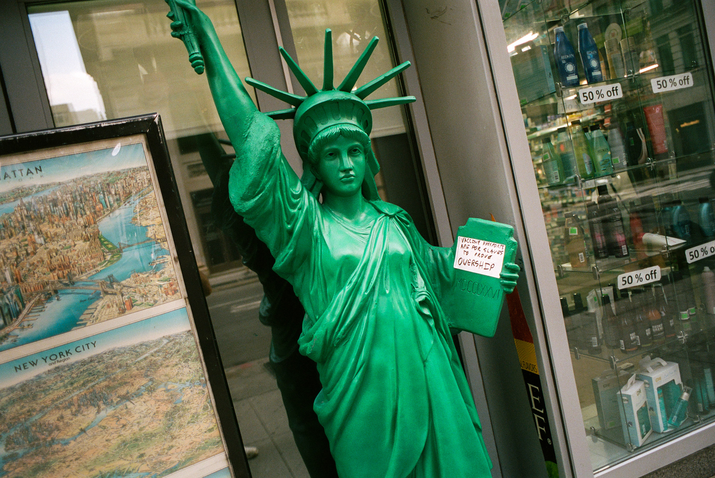 New York, NY - 8/26/21 - A prop Statue Of Liberty inadvertently advertises for anti-vax protestors who have updated the message on her tablet.