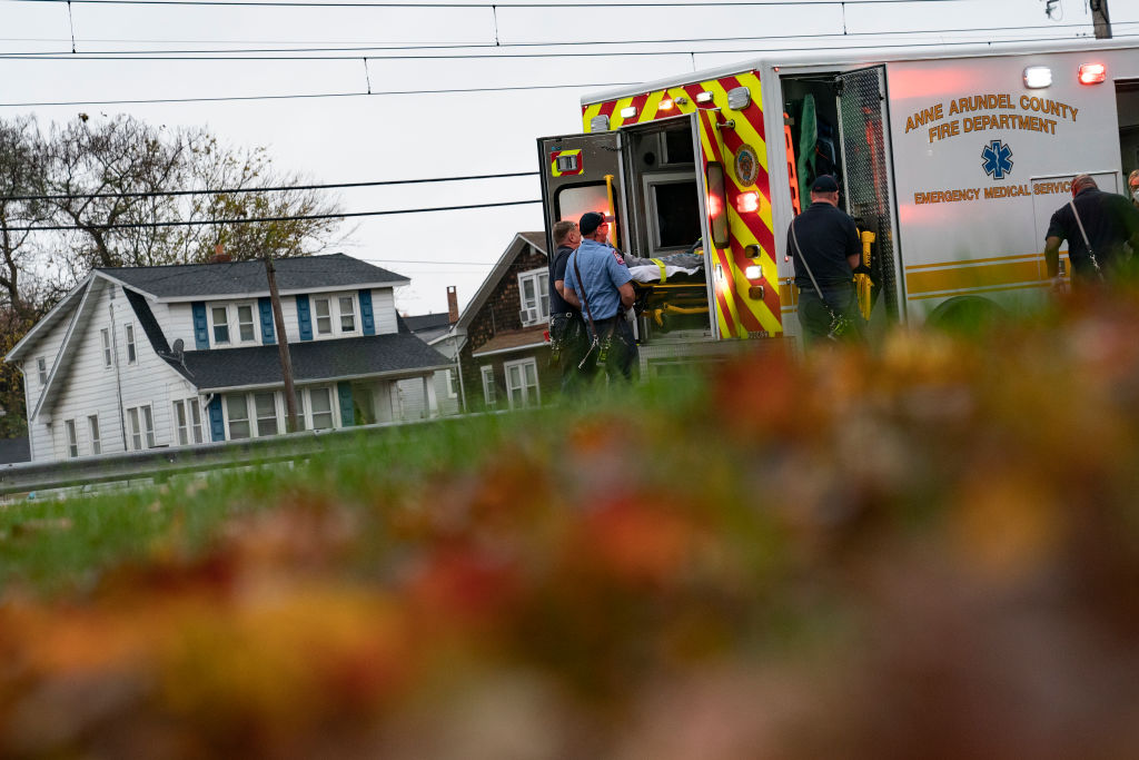 Firefighters and paramedics with Anne Arundel County Fire Department load a patient into an ambulance while responding to a 911 emergency call on November 11, 2020 in Glen Burnie, Maryland. (Alex Edelman / Getty Images)