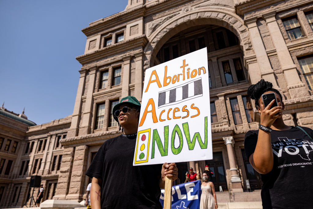A woman carries a sign calling for access to abortion at a rally at the Texas State Capitol on September 11, 2021 in Austin, Texas. Texas Lawmakers recently passed several pieces of conservative legislation, including SB8, which prohibits abortions in Texas after a fetal heartbeat is detected on an ultrasound, usually between the fifth and sixth weeks of pregnancy. (Photo by Jordan Vonderhaar/Getty Images)