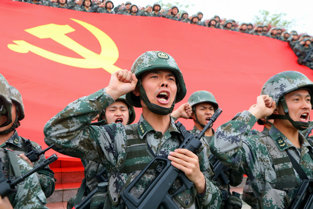 Soldiers seen in front of the flag of the Communist Party of China at an official event on April 13, 2021 in Luoyang, Henan Province, China. (Jia Fangwen/VCG via Getty Images)