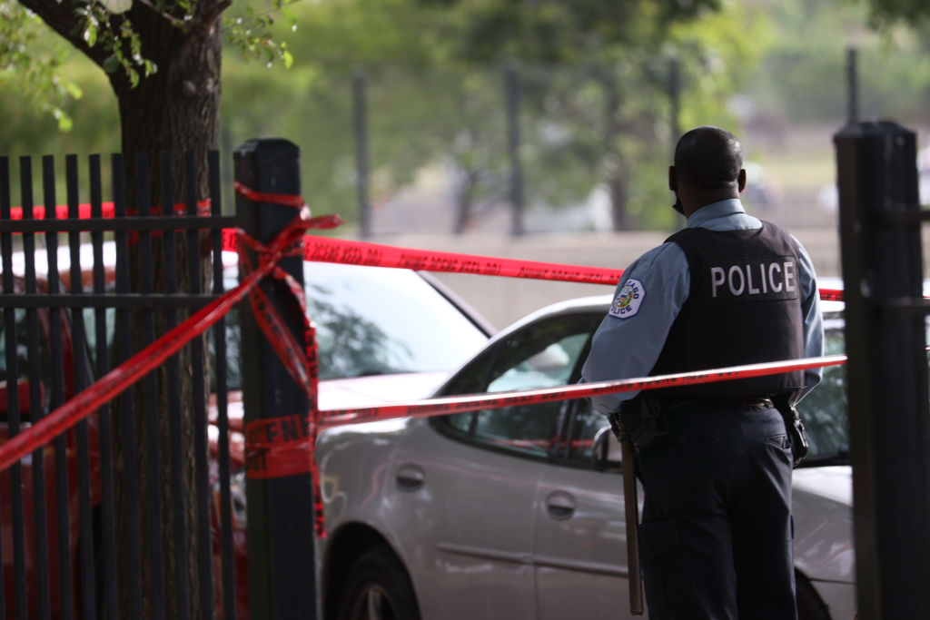 Police investigate a crime scene where three people were shot on June 23, 2021 in Chicago, Illinois. (Scott Olson—Getty Images)