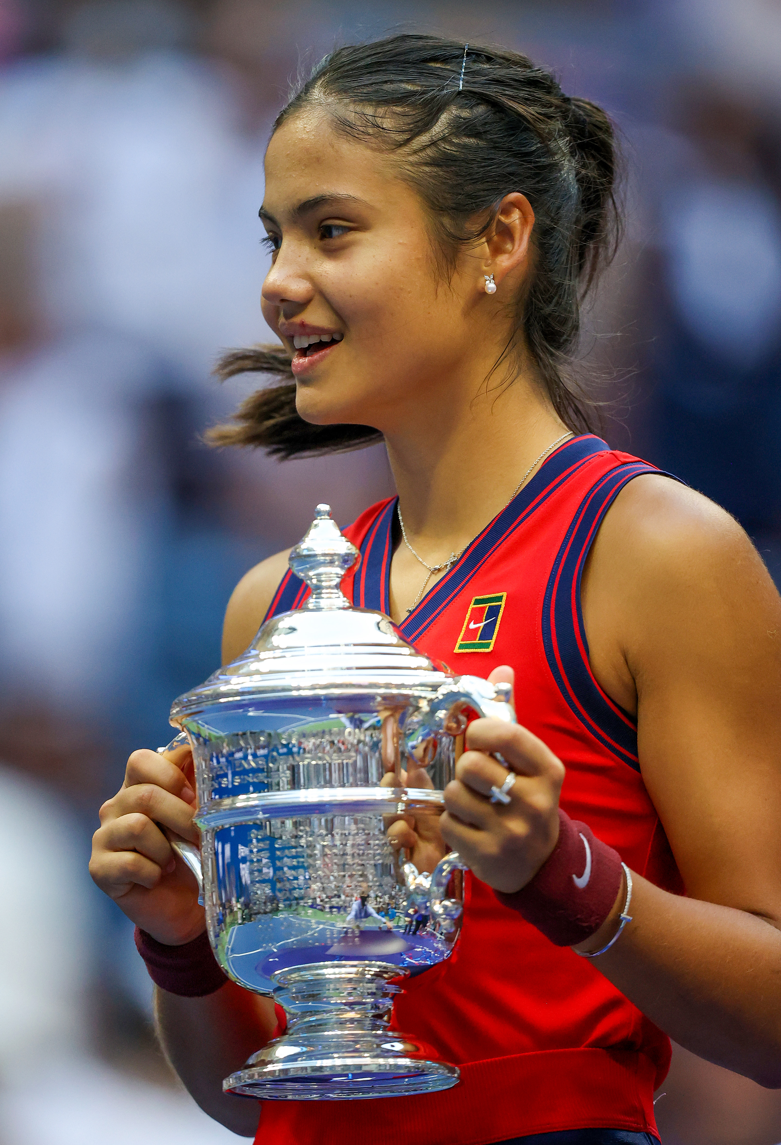 Emma Raducanu of Great Britain celebrates with the championship trophy after defeating Leylah Annie Fernandez of Canada during their Women's Singles final match on Day Thirteen of the 2021 US Open at the USTA Billie Jean King National Tennis Center on Sept. 11, 2021 in New York City. (Al Bello—Getty Images)