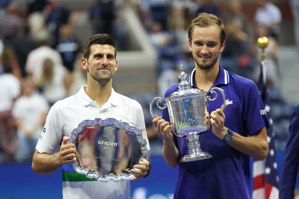 Novak Djokovic of Serbia holds the runner-up trophy alongside Daniil Medvedev of Russia who celebrates with the championship trophy after winning their Men's Singles final match on Day Fourteen of the 2021 US Open at the USTA Billie Jean King National Tennis Center on September 12, 2021 in New York City.  (Photo by Matthew Stockman/Getty Images)