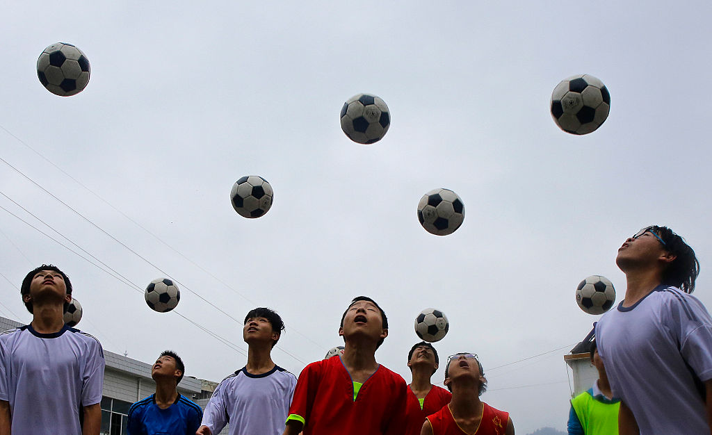 Chinese students are seen during a football training session in the campus of the Yuyang Middle School in Wufeng Tujia Nationality Autonomous County of Yichang on June 1, 2016, in Hubei province, China. (Getty Images—2016 Wang He)