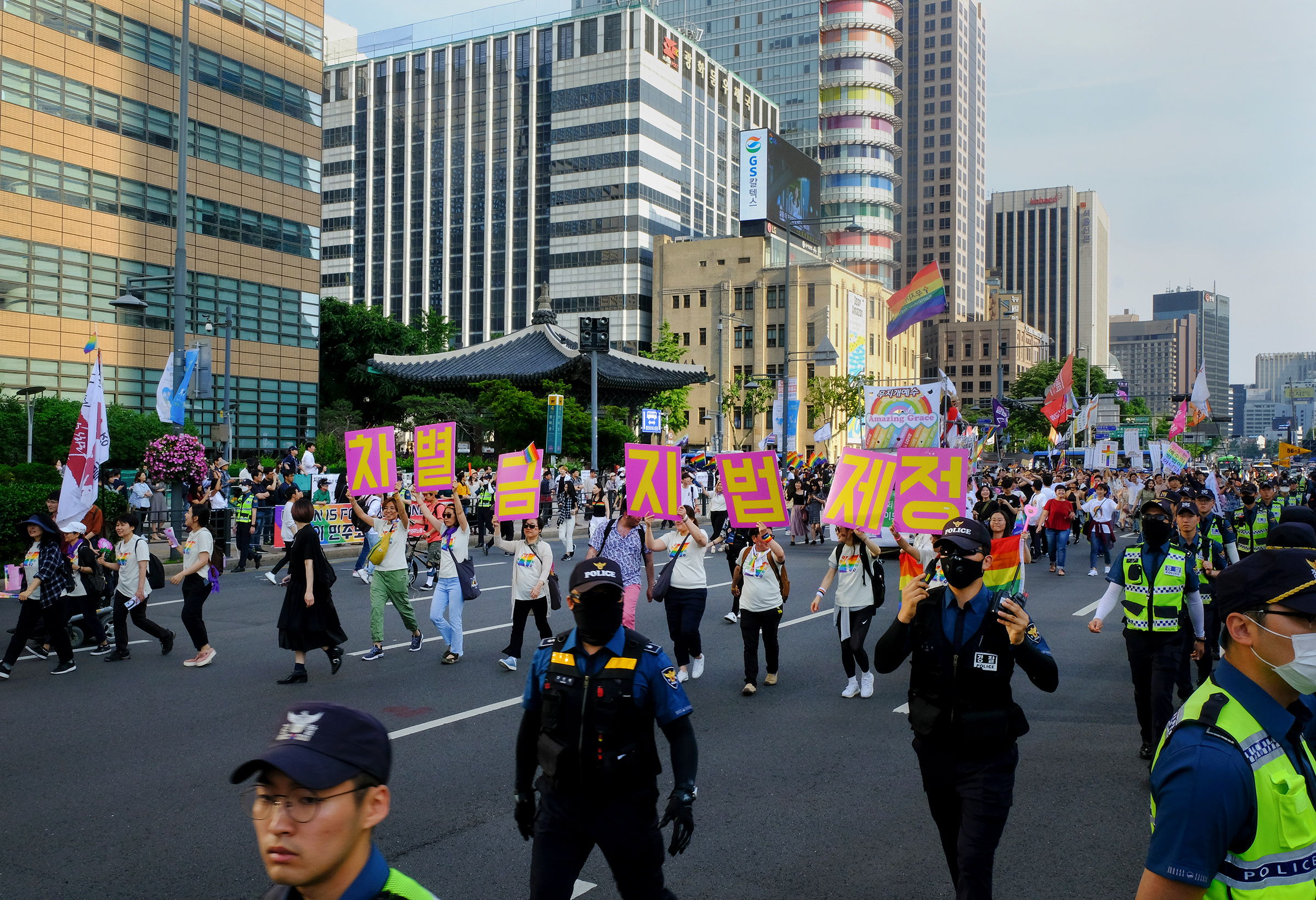 LGBTQ rights protesters hold signs that read, "Enact an Anti-Discrimination Law" at Gwanghwamun Plaza during the Seoul Queer Culture Festival on June 1, 2019. (Sangsuk Sylvia Kang)
