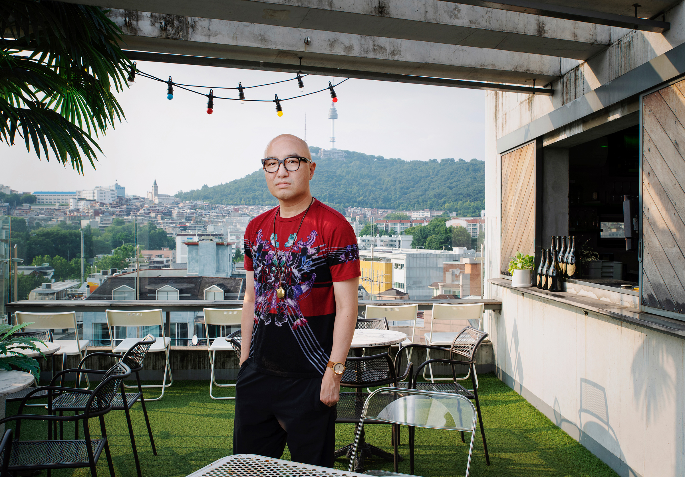 <b>Hong Seok-cheon</b> poses for a portrait in where used to be his rooftop restaurant, My Sky, in Itaewon, Seoul, on June 23. "All around the world, there are neighborhoods here and there that recognize diversity," he says. "I think in Korea, that's Itaewon. And I realized my dream and spent my youth here." After coming out in 2000 and being ousted from television jobs, he opened restaurants in the neighborhood. "I wanted to create spaces where LGBTQ people would coexist with the heterosexual community. So I chose restaurants. Of course, it was difficult at first. The people who came to our restaurant had a very preconceived notion because I was the owner. But as time passed, people recognized my sincerity and hard work and really enjoyed those spaces. It's very sad that they are gone." He says that he feels constant pressure to become a successful LGBTQ role model for Koreans, a burden he has been singularly carrying as the most prominent celebrity who has come out. (Sangsuk Sylvia Kang for TIME)