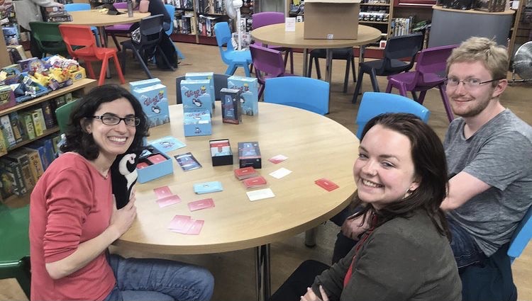 Molly Zeff playing Wing It with two customers at the Fan Boy Three game store in Manchester, England, in 2019. (Flying Leap Games)