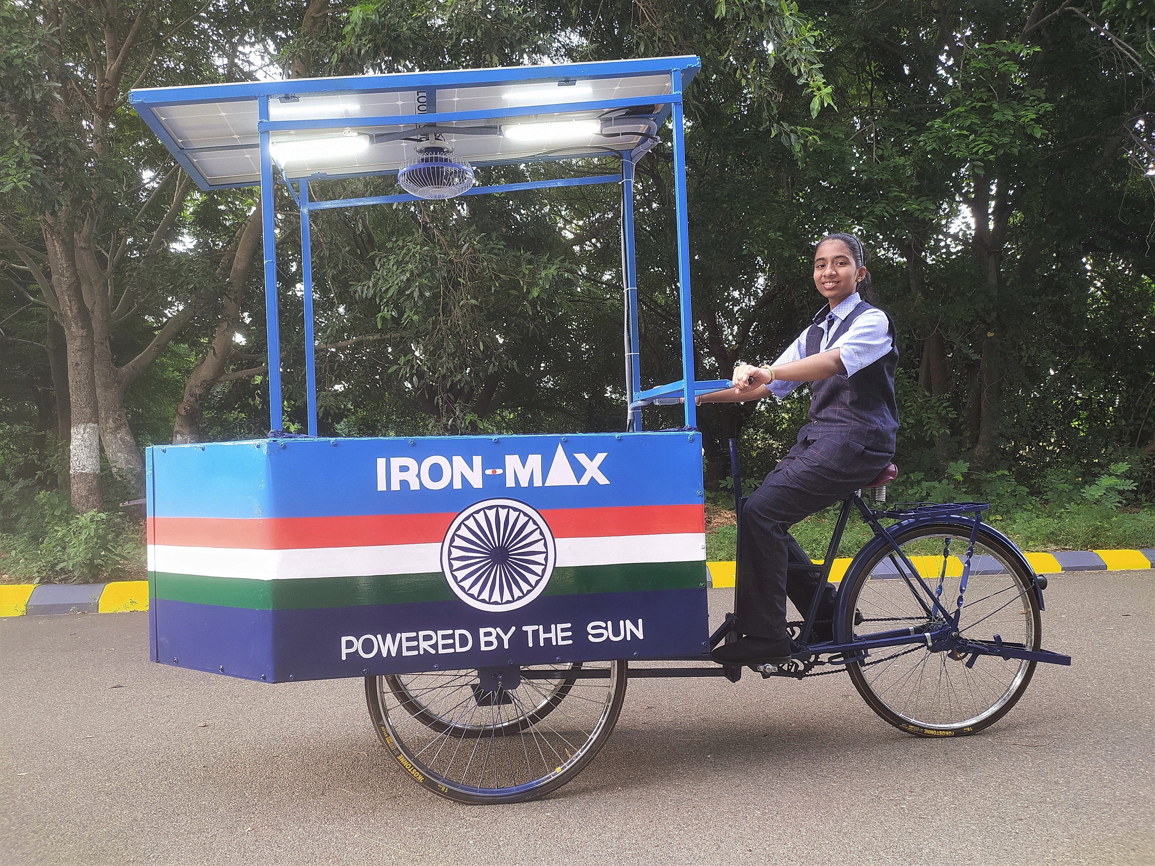 14-year-old Vinisha Umashankar rides the solar-powered iron cart that she designed in Tiruvannamalai, India. (Courtesy Vinisha Umashankar)
