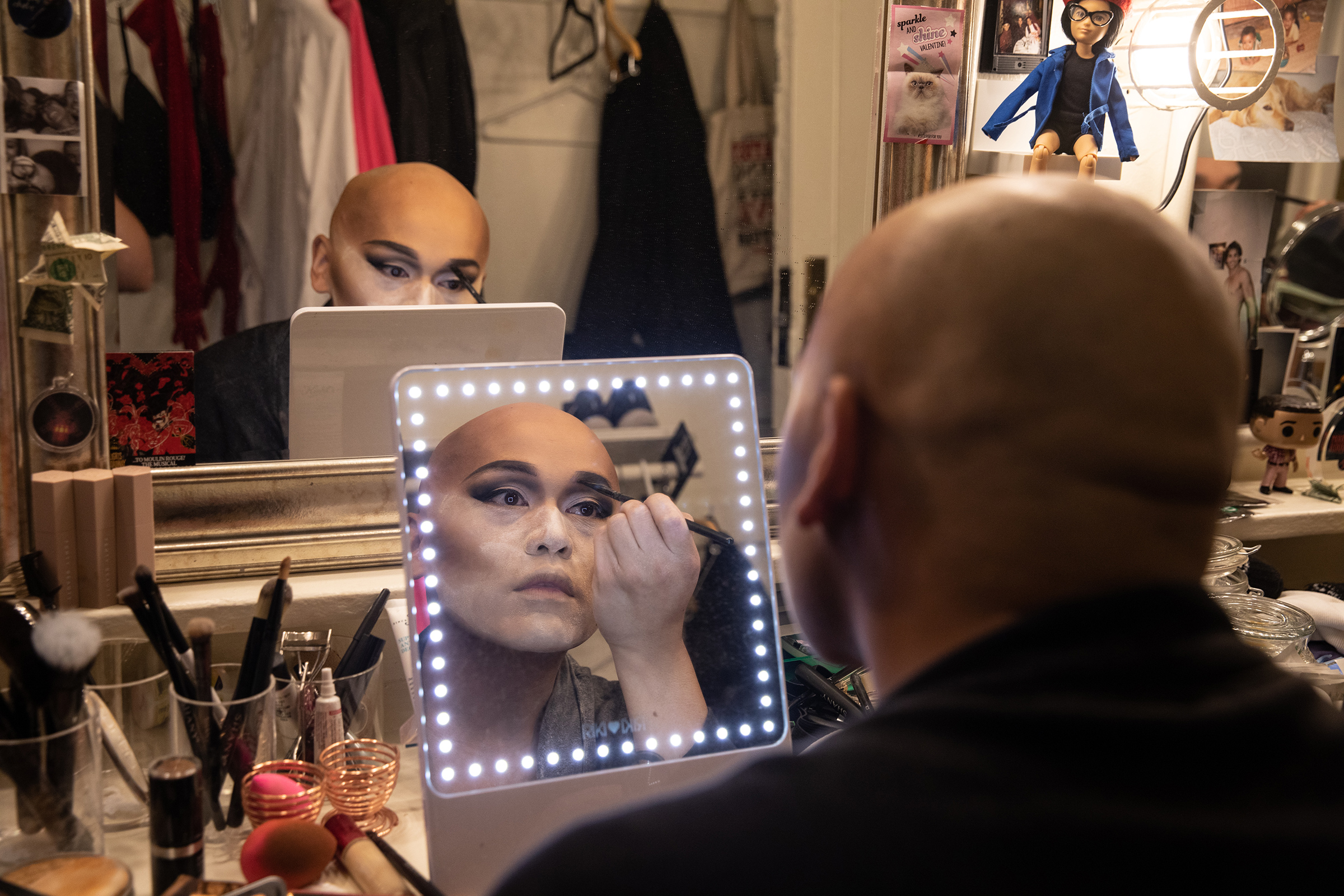 Actor, Jeigh Madjus who plays 'Babydoll' doing his makeup in the dressing room backstage before rehearsal for Moulin Rouge! on Sept. 21, 2021. Madjus says sometimes his makeup can take up to two hours to complete.