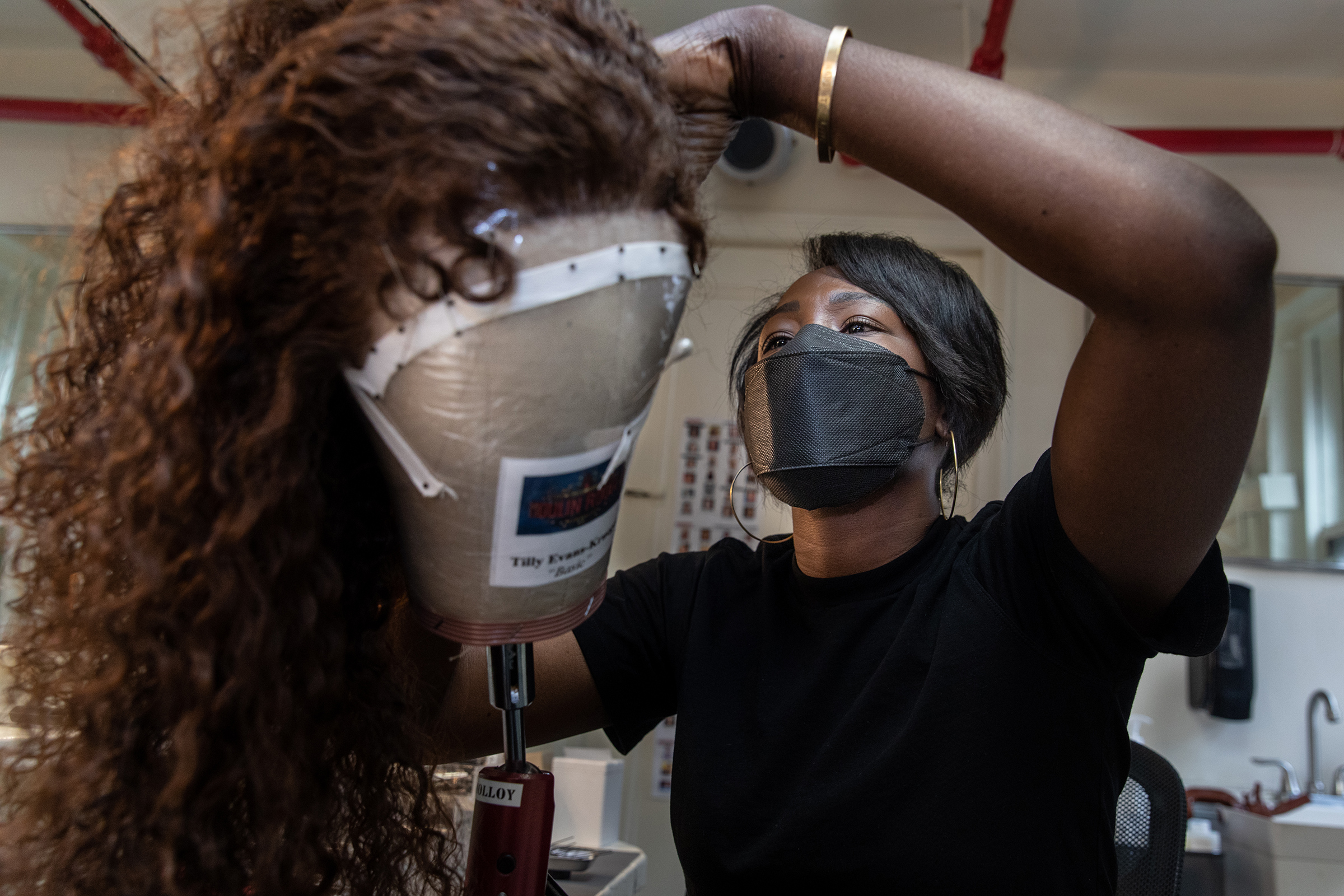 Hairdresser Akilah Abrams prepares a wig in the hair room on Sept. 21, 2021. <i>Moulin Rouge!</i> is her Broadway debut.