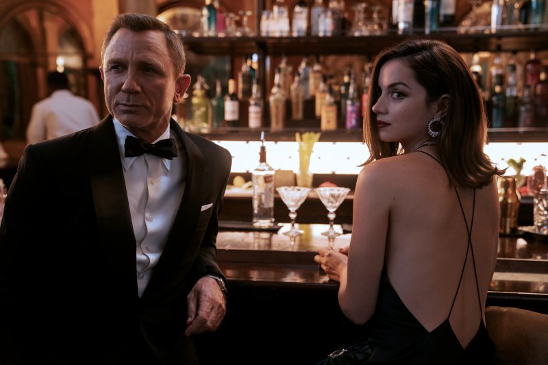 James Bond (Daniel Craig) and Paloma (Ana de Armas)