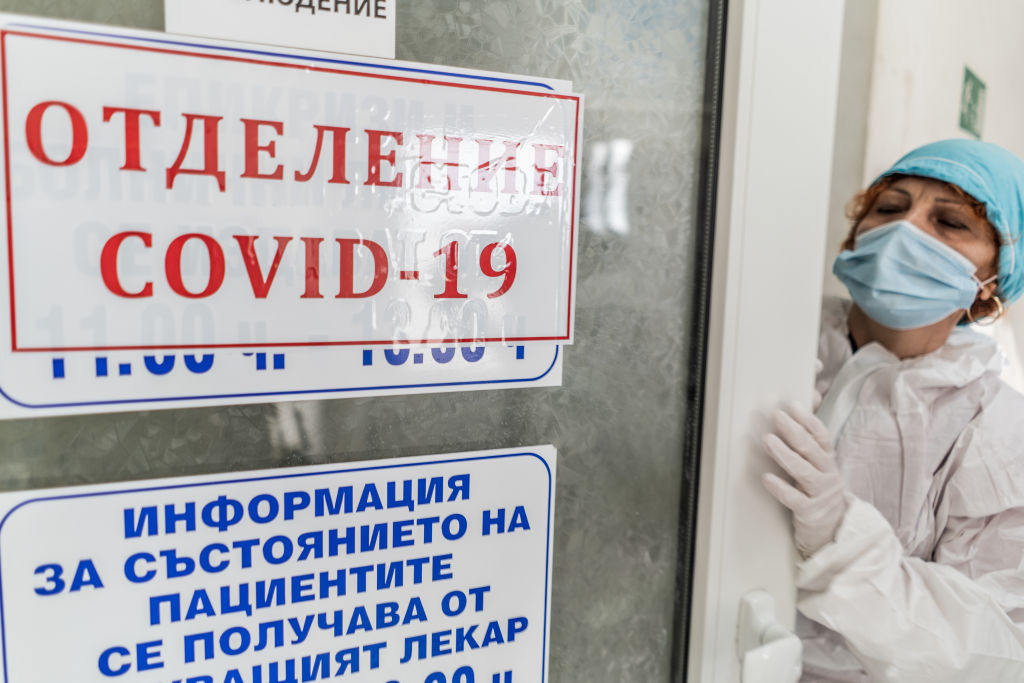 A doctor is seen wearing protective equipment before entering a coronavirus patients room in the ICU of Haskovo Hospital, Bulgaria, on Nov. 5 2020. (Hristo Rusev—Getty Images)