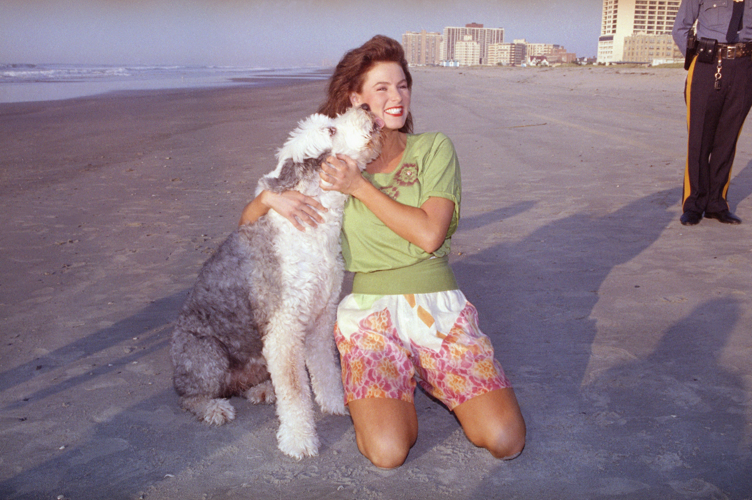 Jade, an Old English sheepdog, licks the face of the newly-crowned Miss America, Carolyn Sapp, during the traditional walk on the beach in Atlantic City, N.J. on Sept, 15, 1991. (Mike Derer—AP)