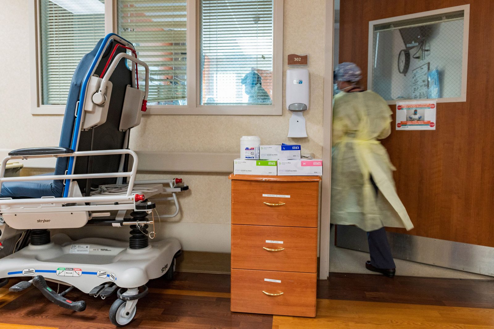 A nurse enters a Covid-19 patient's room inside the ICU at Adventist Health in Sonora, Calif., on Aug. 27, 2021.