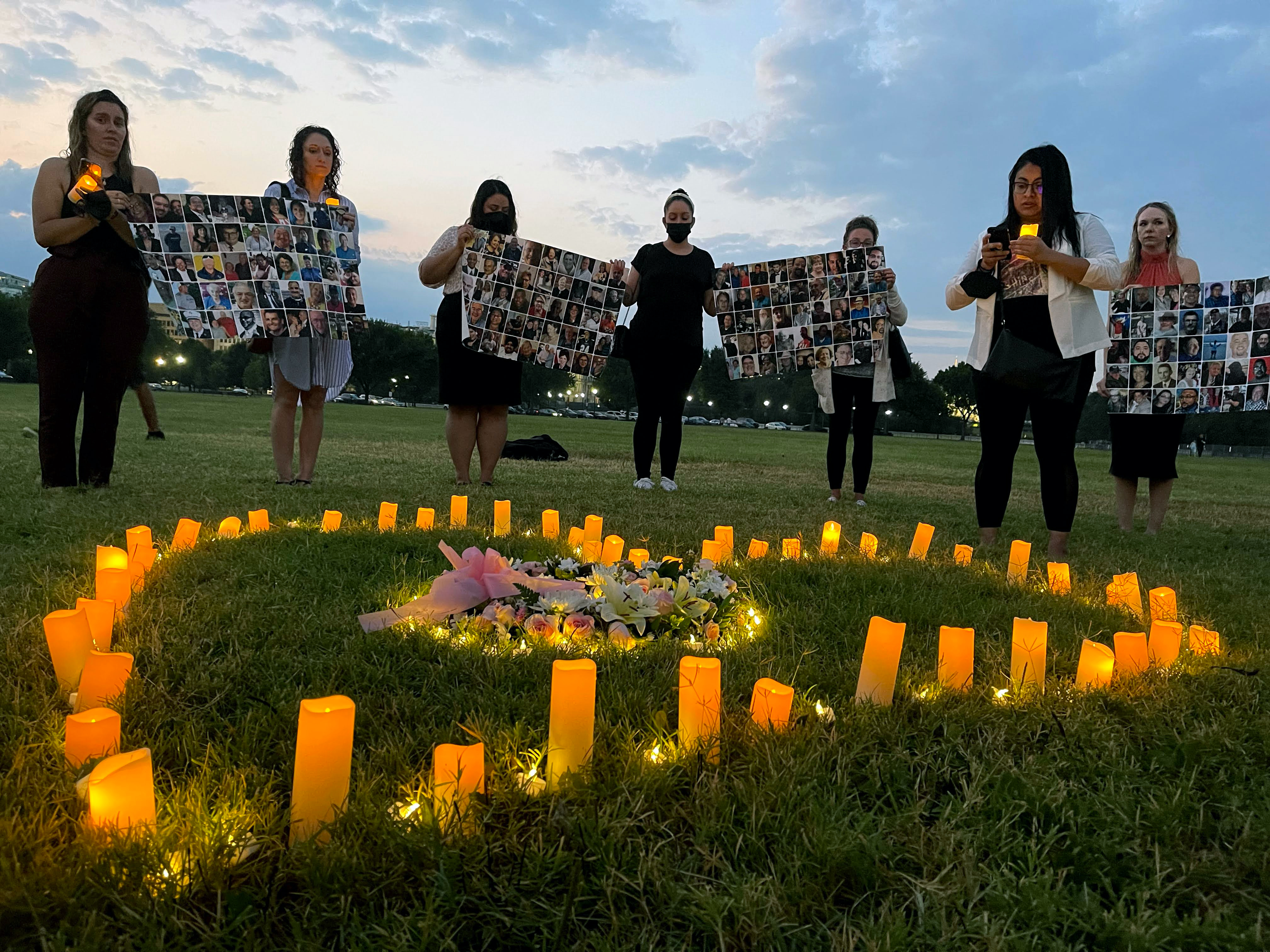 Activists lobbying in Washington D.C. hold up images of lost loved ones at a lighting ceremony on July 26, 2021. (Rima Samman)
