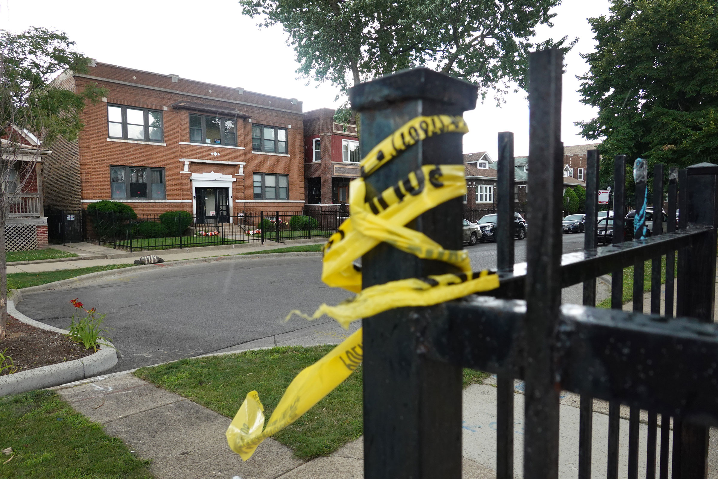 Crime scene tape remains on a fence near the Rhodes funeral home in the Auburn Gresham neighborhood, where at least 15 people were shot during a funeral, in Chicago on July 22, 2020. (Scott Olson—Getty Images)