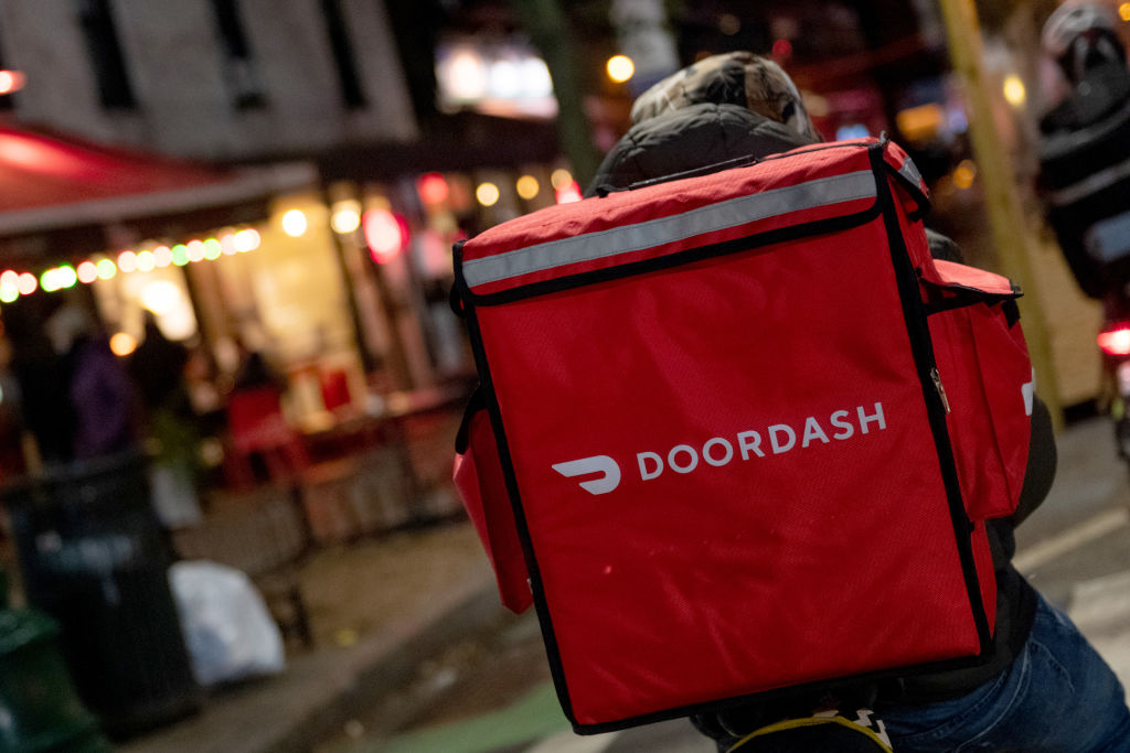 A door-dash delivery driver waits near a restaurant on Dec. 30 2020 in New York City. (Alexi Rosenfeld—Getty Images)