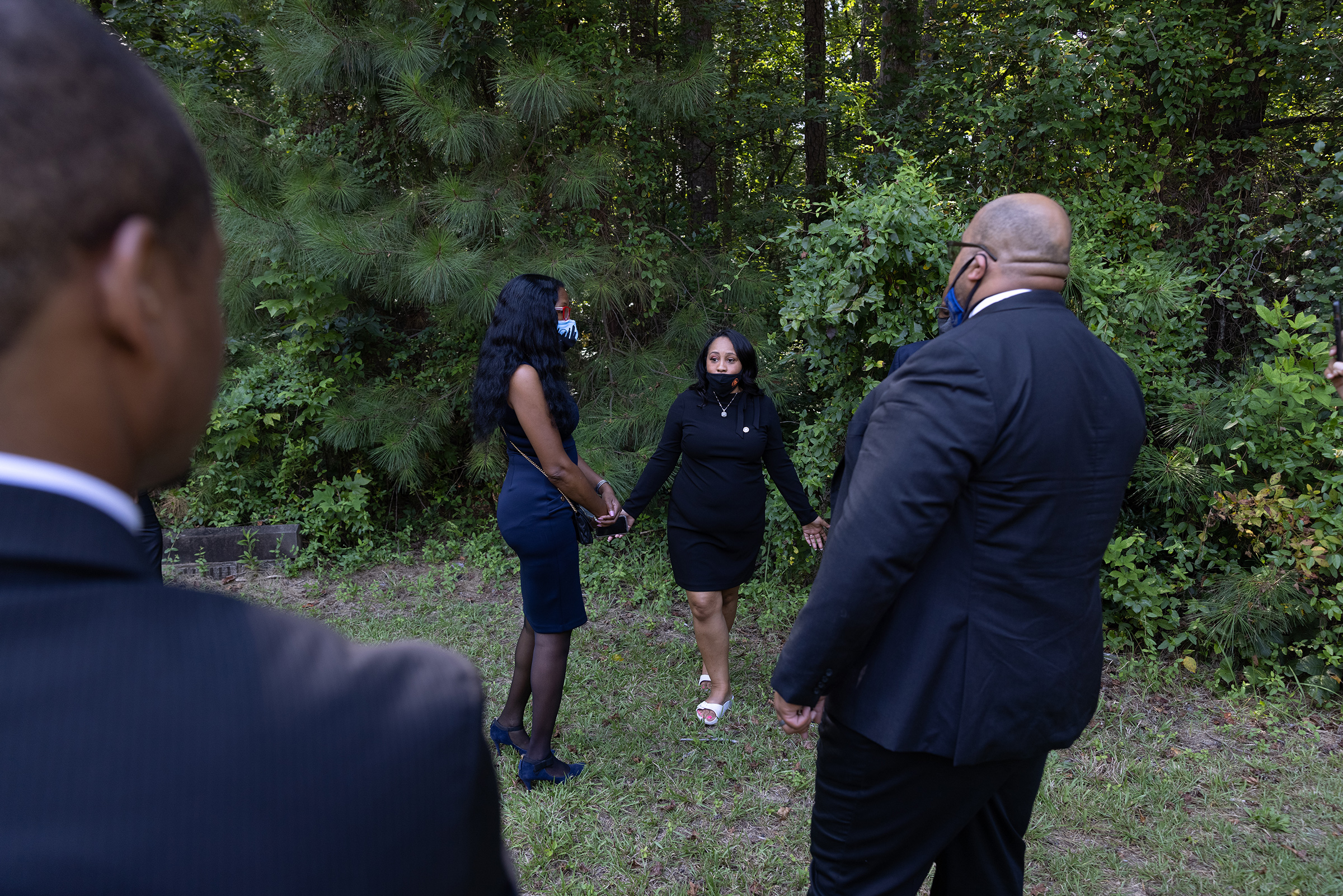 Willis, surrounded by staff, tours the outdoor area of a building in South Fulton County that needs to raise money so that it may be used for diversion and alternative punishment programs.