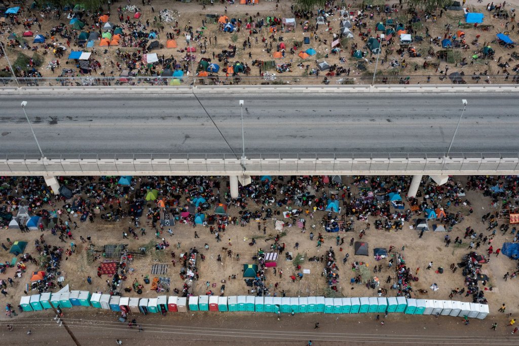 Some thousands of migrants take shelter as they await to be processed near the Del Rio International Bridge after crossing the Rio Grande river into the U.S. from Ciudad Acuna on Sept. 18. Picture taken with a drone.