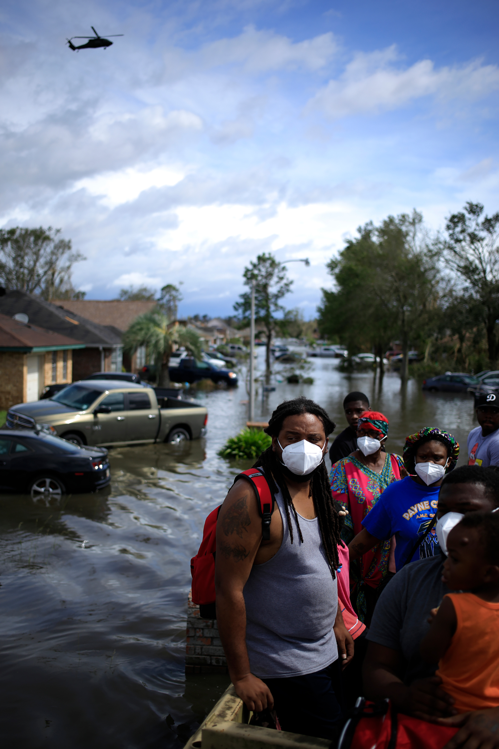 Residents ride in a high water vehicle after being rescued from floodwater left behind by Hurricane Ida in LaPlace, La. on Aug. 30. (Luke Sharrett—Bloomberg/Getty Images)