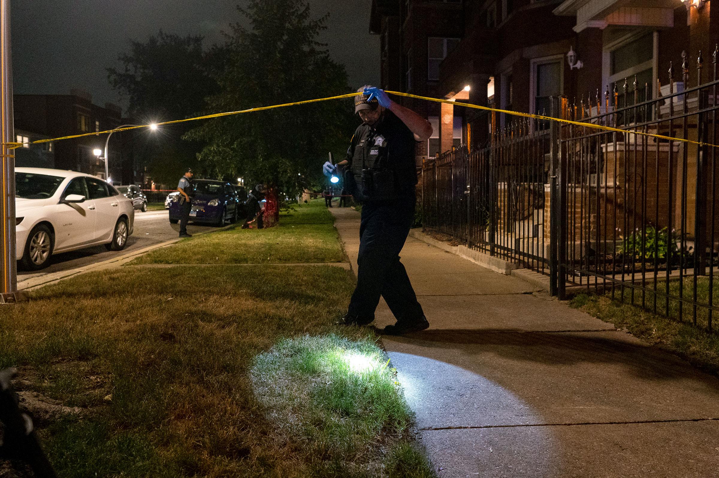 Chicago police at the scene of a shooting in the Woodlawn neighborhood of Chicago, Friday, Sept. 3, 2021. A 4-year-old boy was shot twice when bullets came through the front window of a home, Chicago Police said. (Tyler LaRiviere—Chicago Sun-Times/AP)