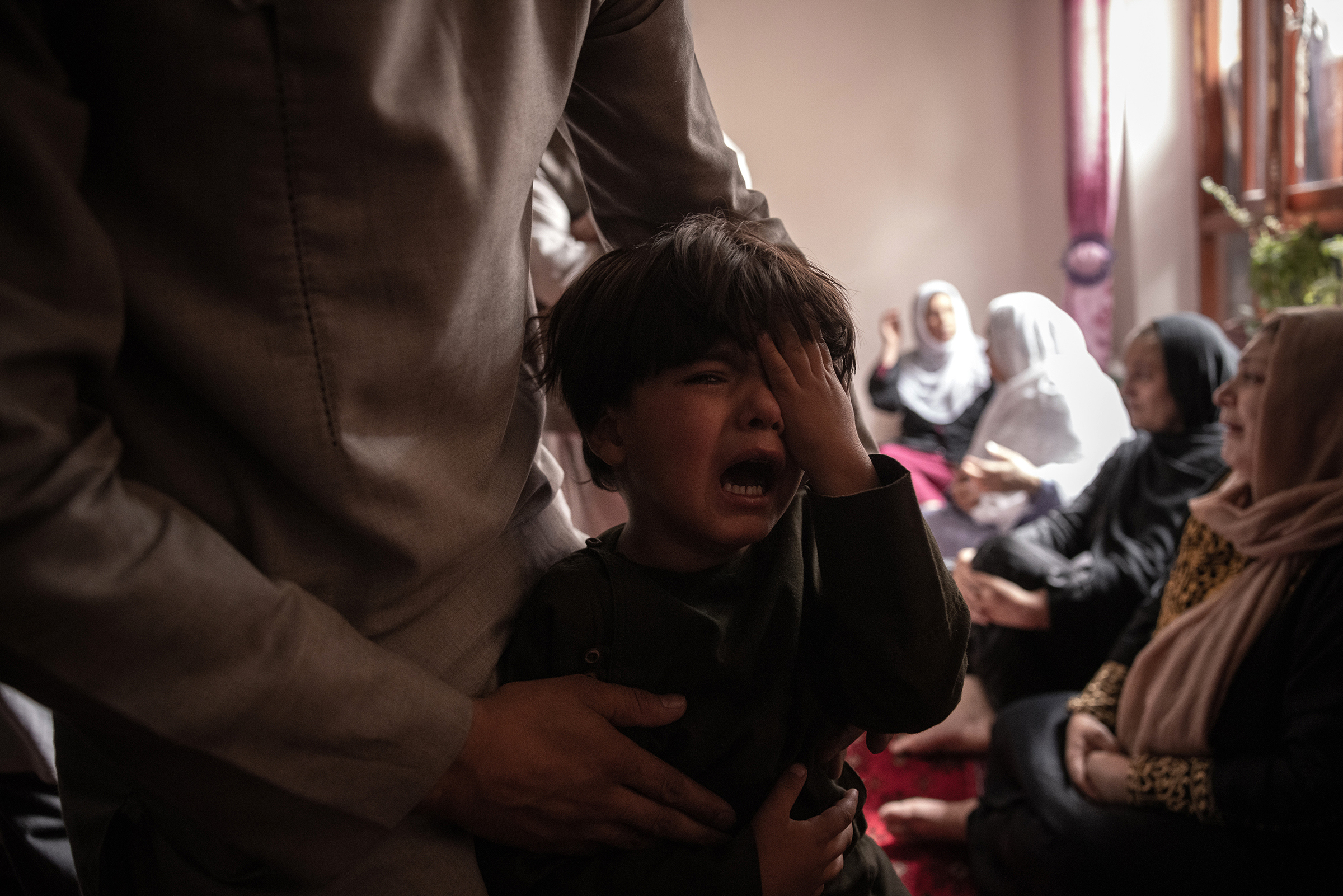 A boy cries over the death of his sister in the drone strike.