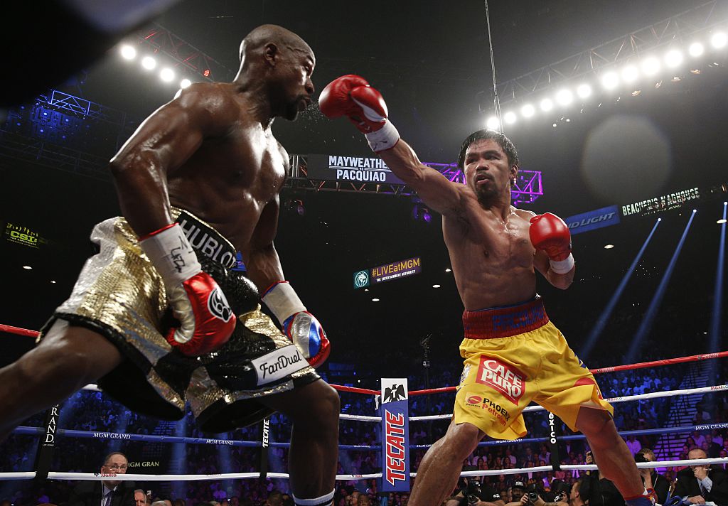 Floyd Mayweather Jr. exchanges punches with Manny Pacquiao during their welterweight unification championship bout on May 2, 2015 at the MGM Grand Garden Arena in Las Vegas, Nevada. (John Gurzinski—AFP/Getty Images)