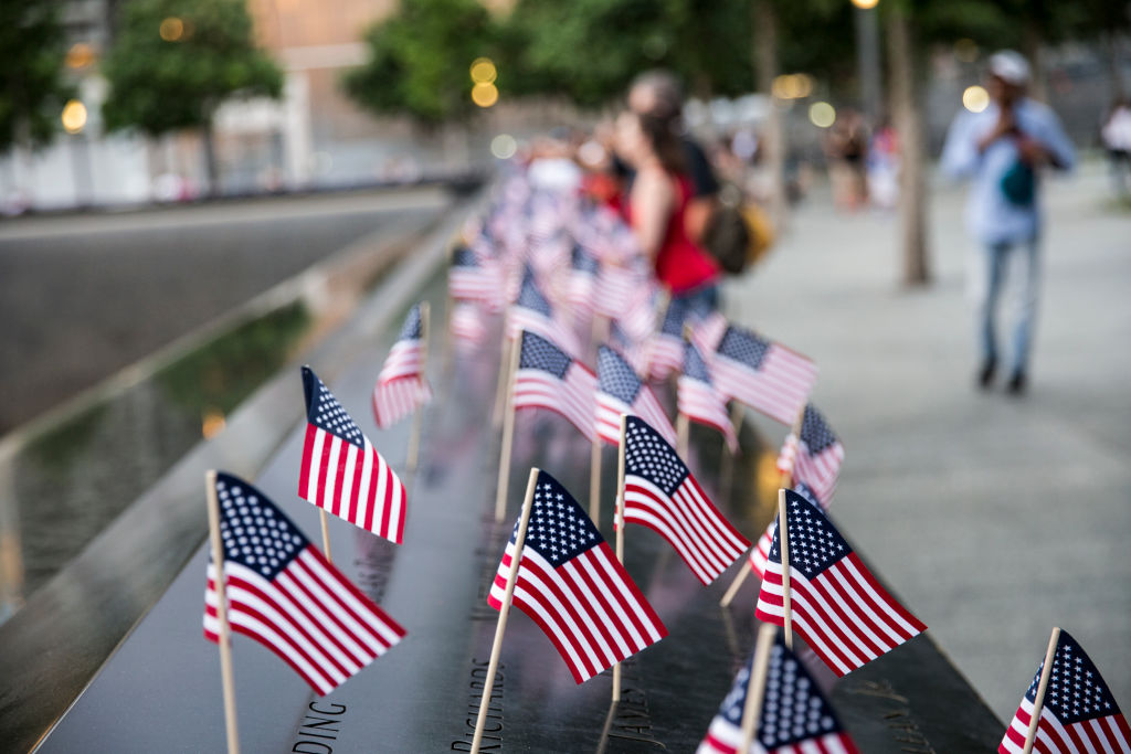 Small American flags are placed in all 2,983 names on the 9/11 Memorial on July 4, 2017, in New York City. (Alex Wroblewski—Getty Images)