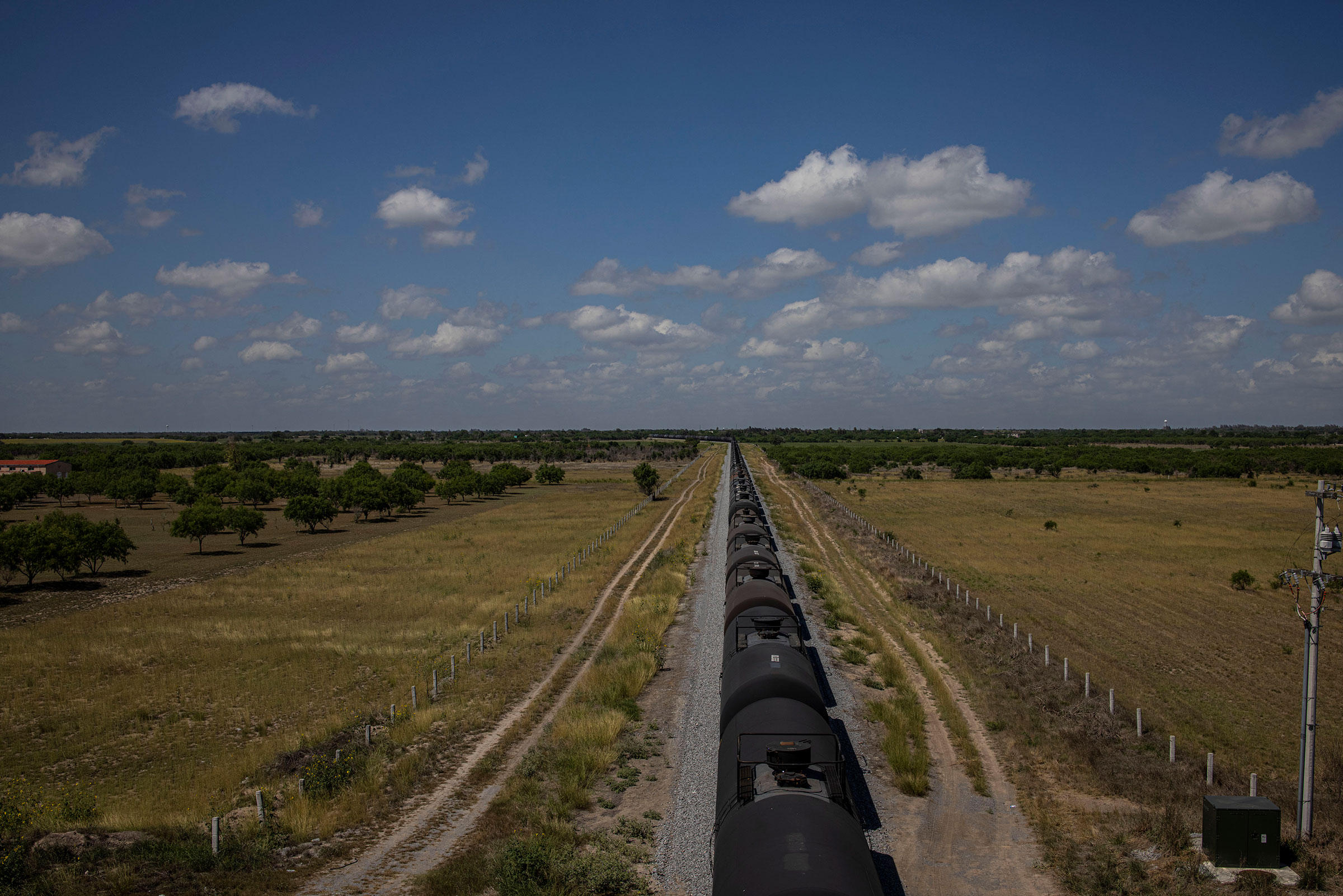 A train runs along the border between Brownsville, Texas, and Matamoros in the Mexican state of Tamaulipas on May 7, 2021. (Yael Martinez—Magnum Photos for TIME)