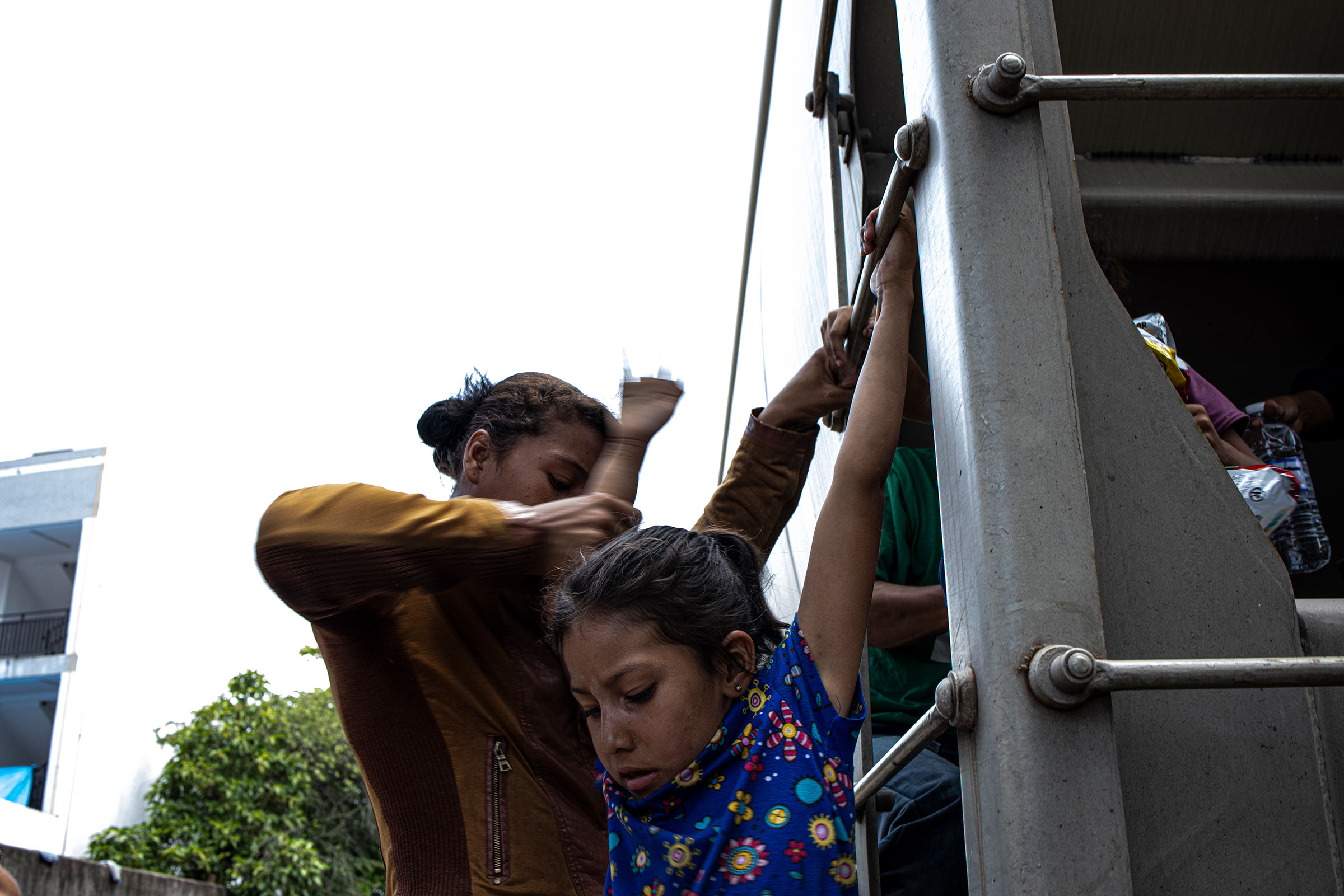 A mother helps her young daughter get off a train in Coatzacoalcos, in the Mexican state of Veracruz on March 22, 2021. Family units have been arriving at the U.S.-Mexico border at an increasing rate since January 2019, according to U.S. Customs and Border Protection data. (Yael Martínez—Magnum Photos for TIME)