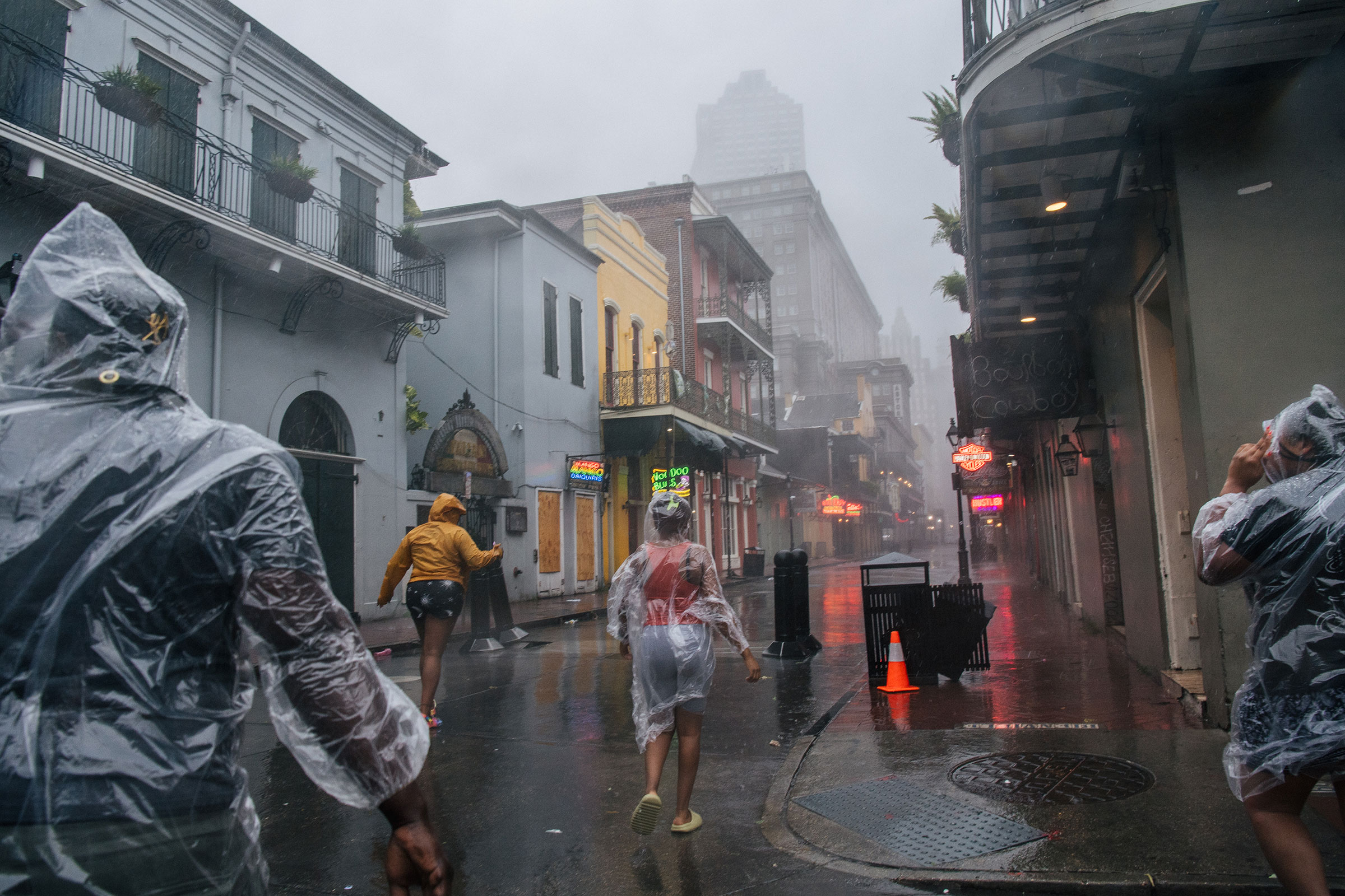 A group of people walk through the French District during Hurricane Ida in New Orleans on Aug. 29, 2021.