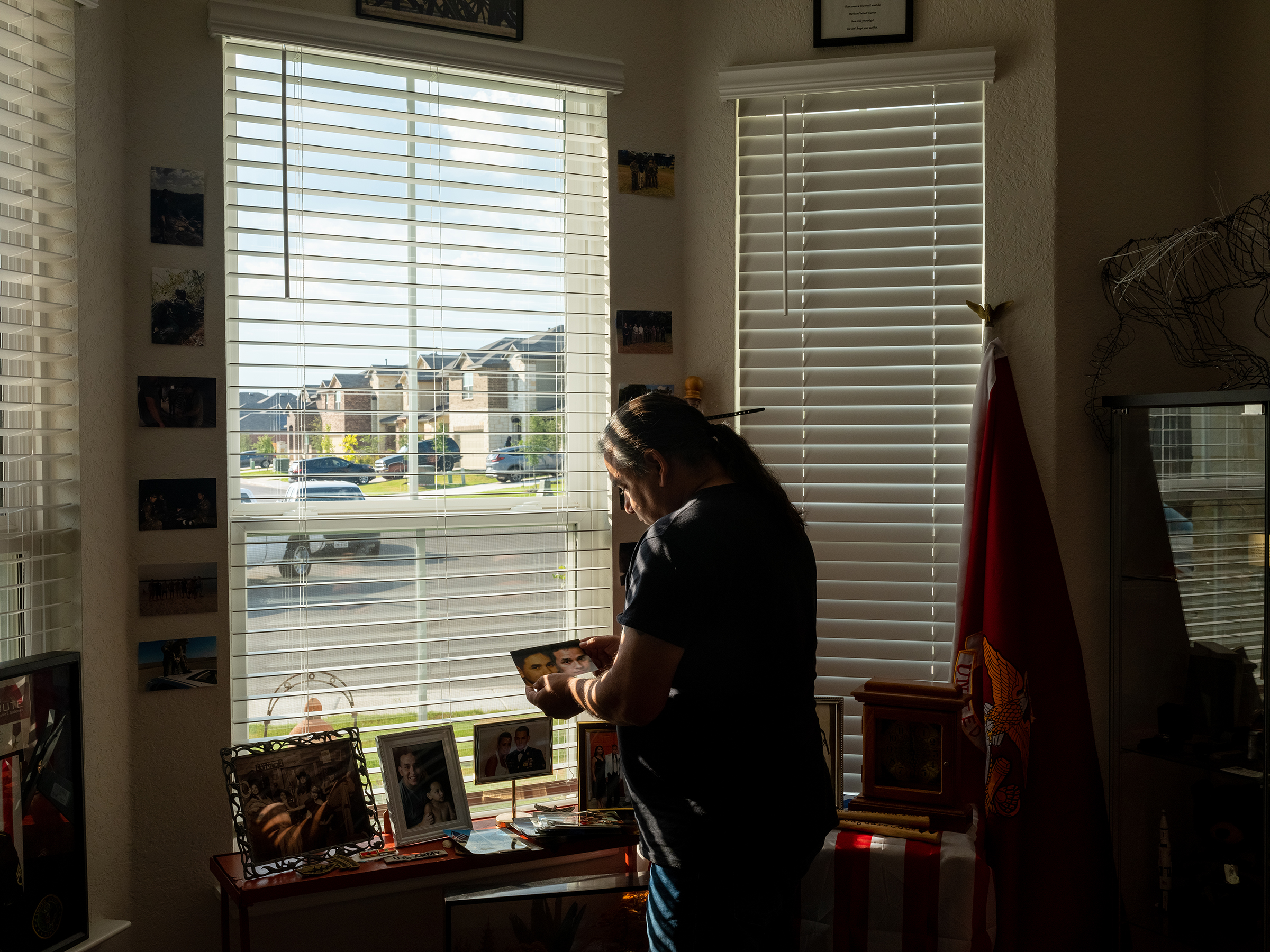 On one of the final days of the U.S. evacuation from Afghanistan, Javier Gutierrez studies a photo of his son.