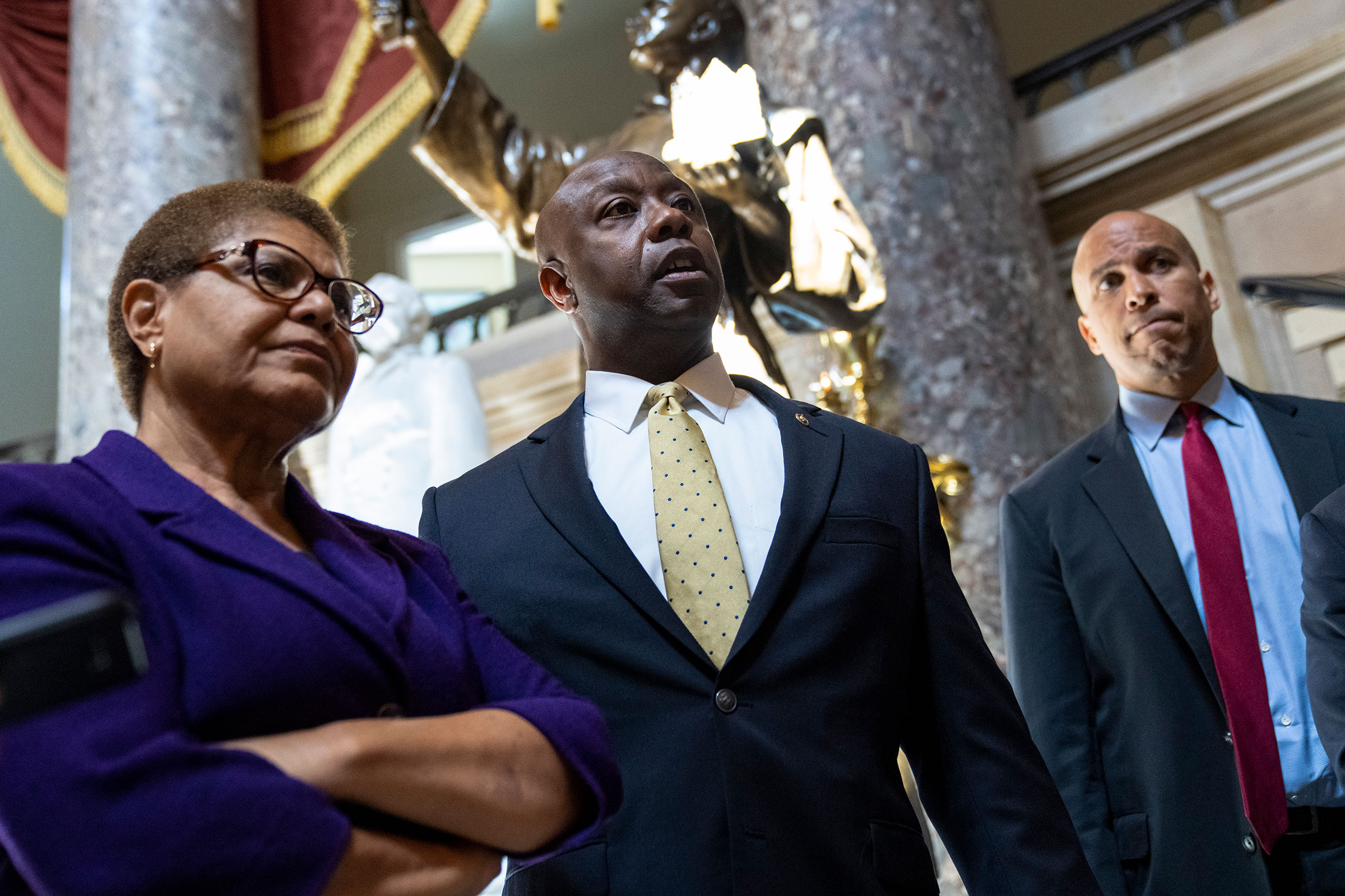 Rep. Karen Bass, Sen. Tim Scott, and Sen. Cory Booker speak briefly to reporters as they exit the office of Rep. James Clyburn following a meeting about police reform legislation on Capitol Hill on May 18, 2021.